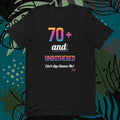 Black t-shirt with colorful text design on a decorative background