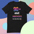Black t-shirt with colorful text design on a multicolored background