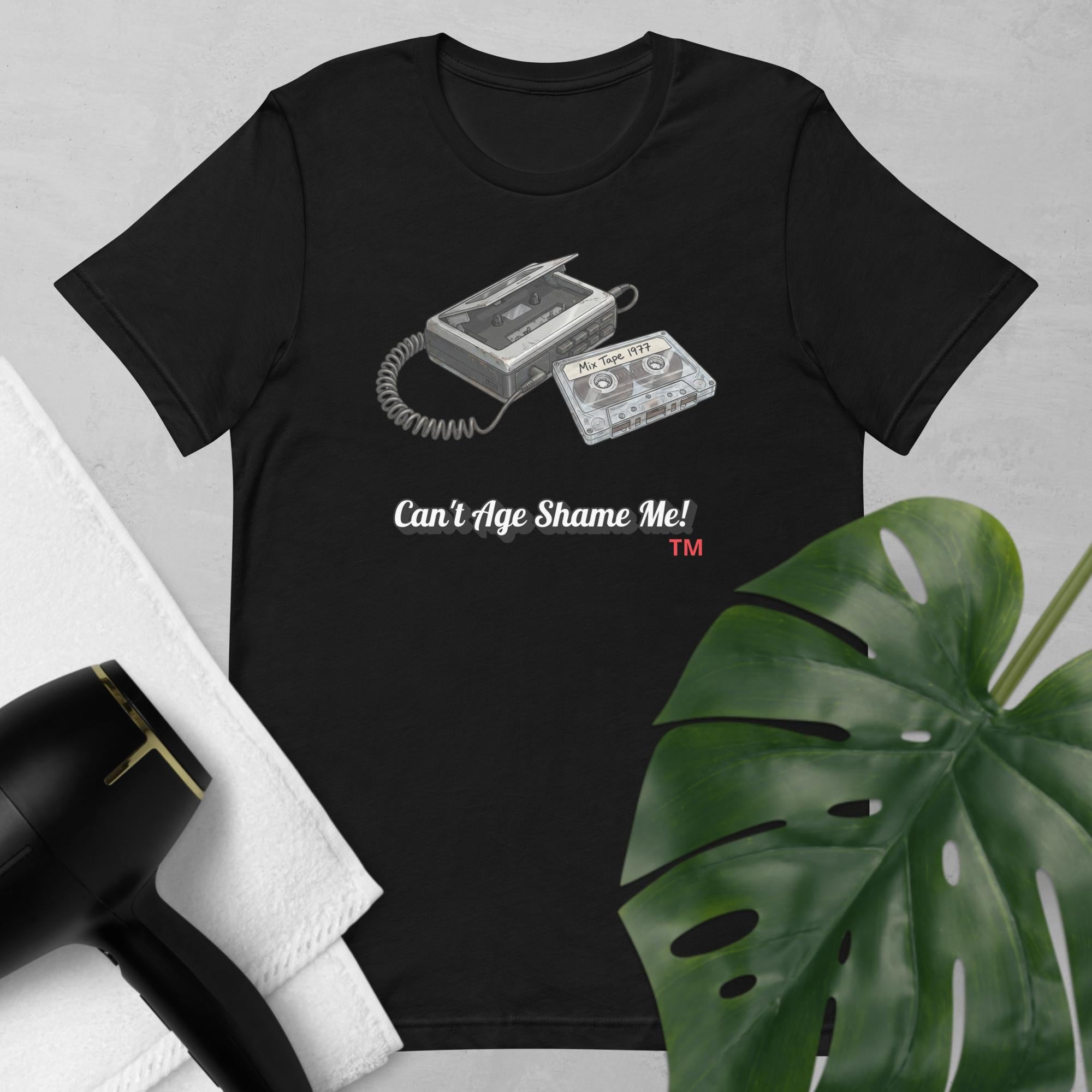 black  t-shirt with cassette tape design and text 'Can't Age Shame Me!' on a light gray background.