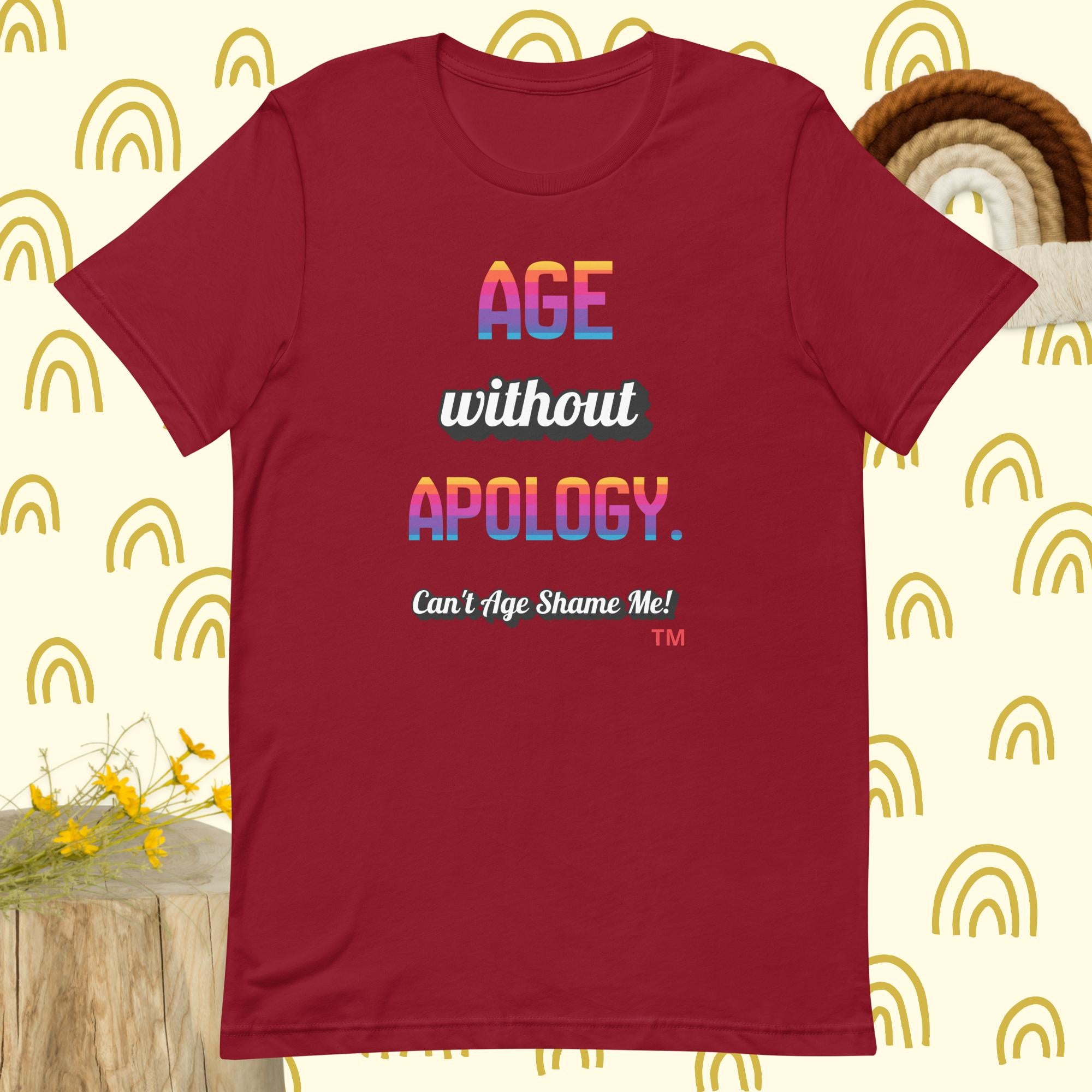 Red t-shirt with colorful text on a patterned background