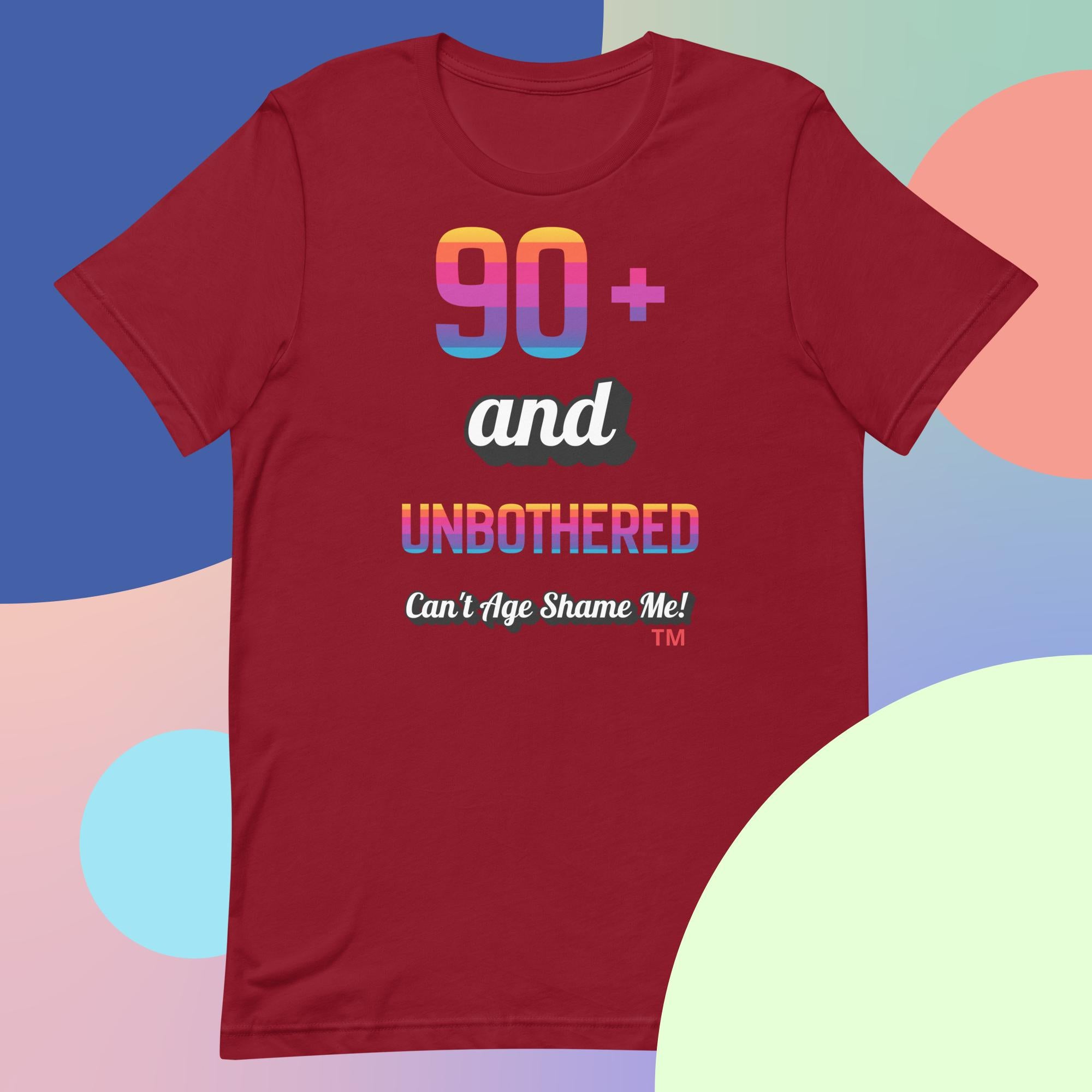 Red t-shirt with colorful text design on a multicolored background