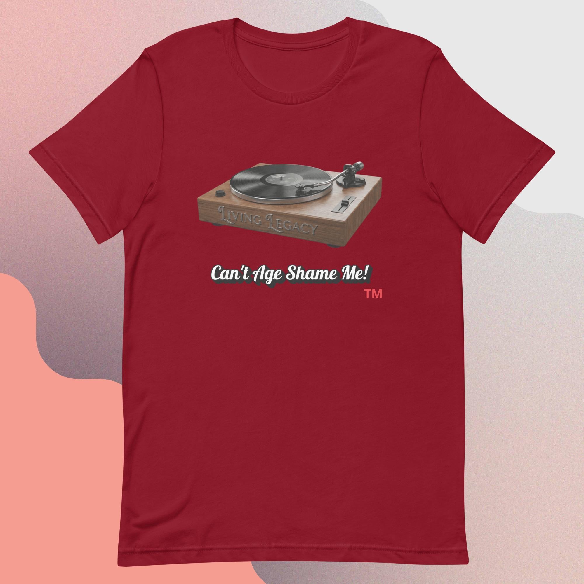 Red t-shirt with a graphic of a turntable and text 'Can't Age Shame Me!' on a gradient background.