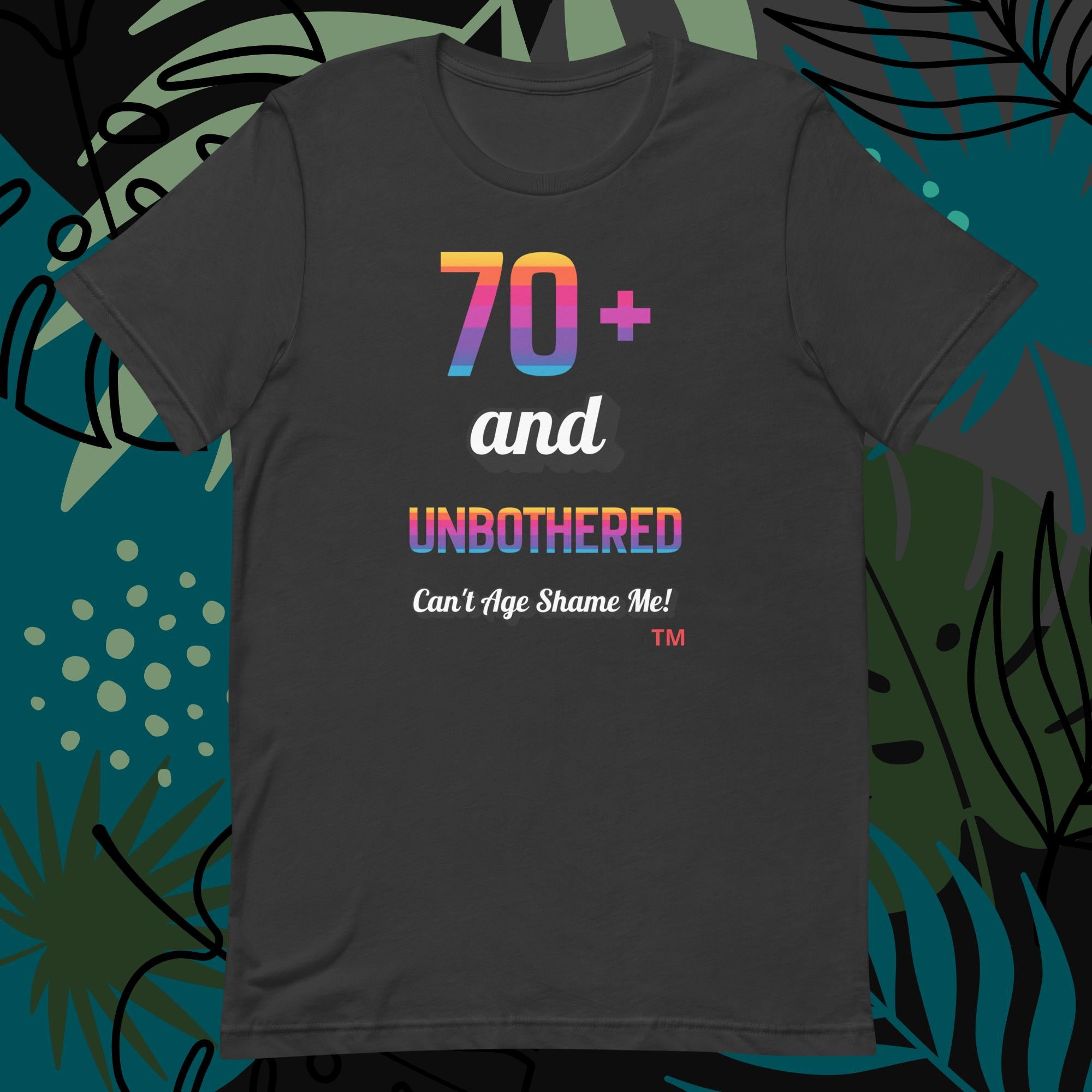 Dark gray t-shirt with colorful text design on a decorative background