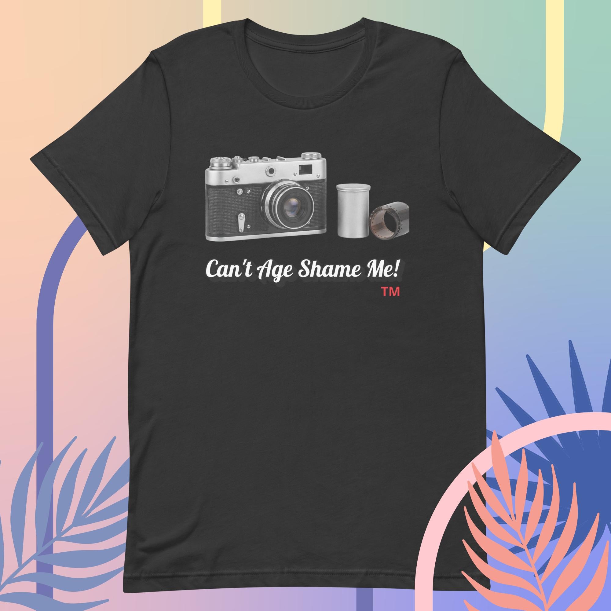 dark gray t-shirt with a camera graphic and text  Can't Age Shame Me! on a colorful background