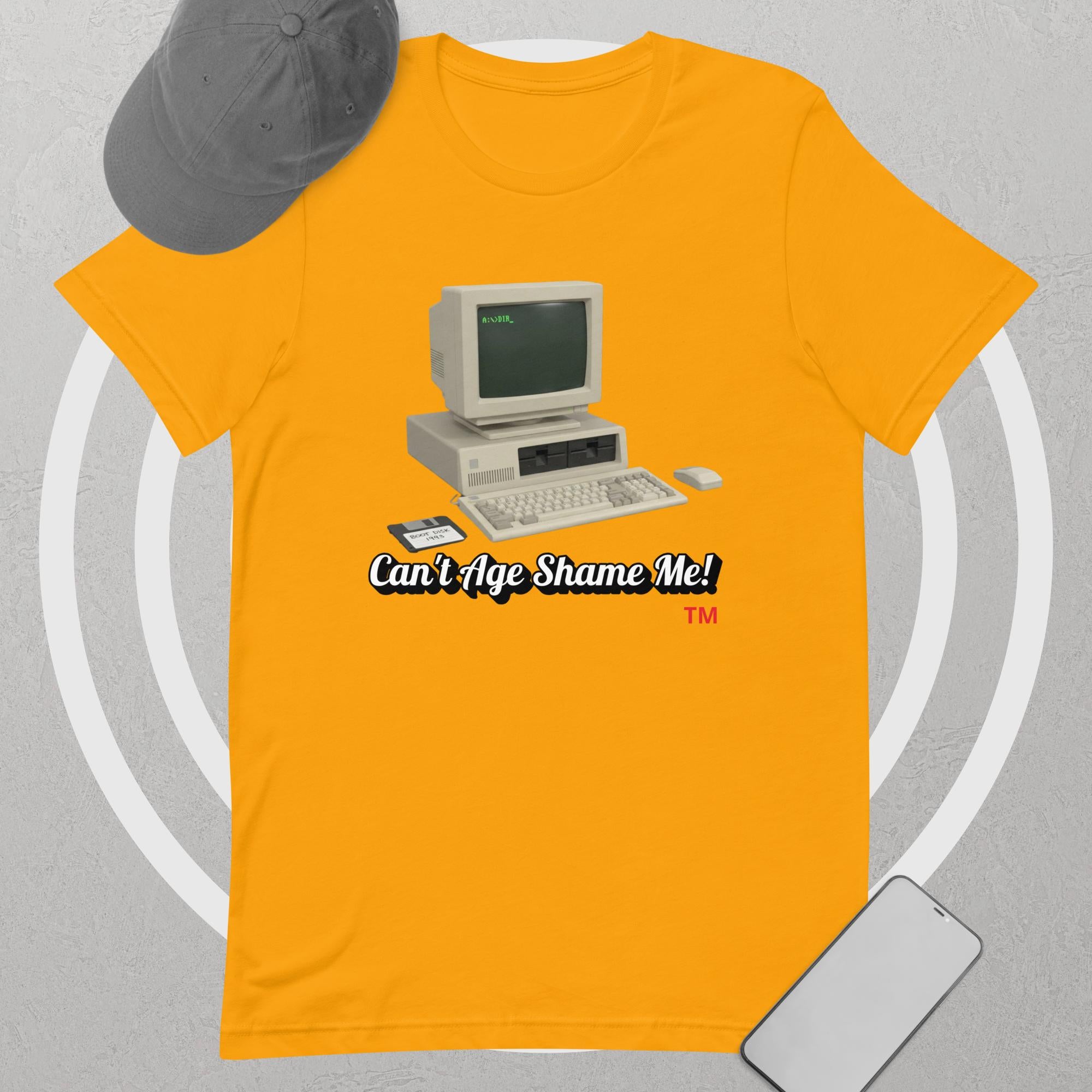 gold  t-shirt with vintage computer graphic and text 'Can't Age Shame Me!' on a gray background.