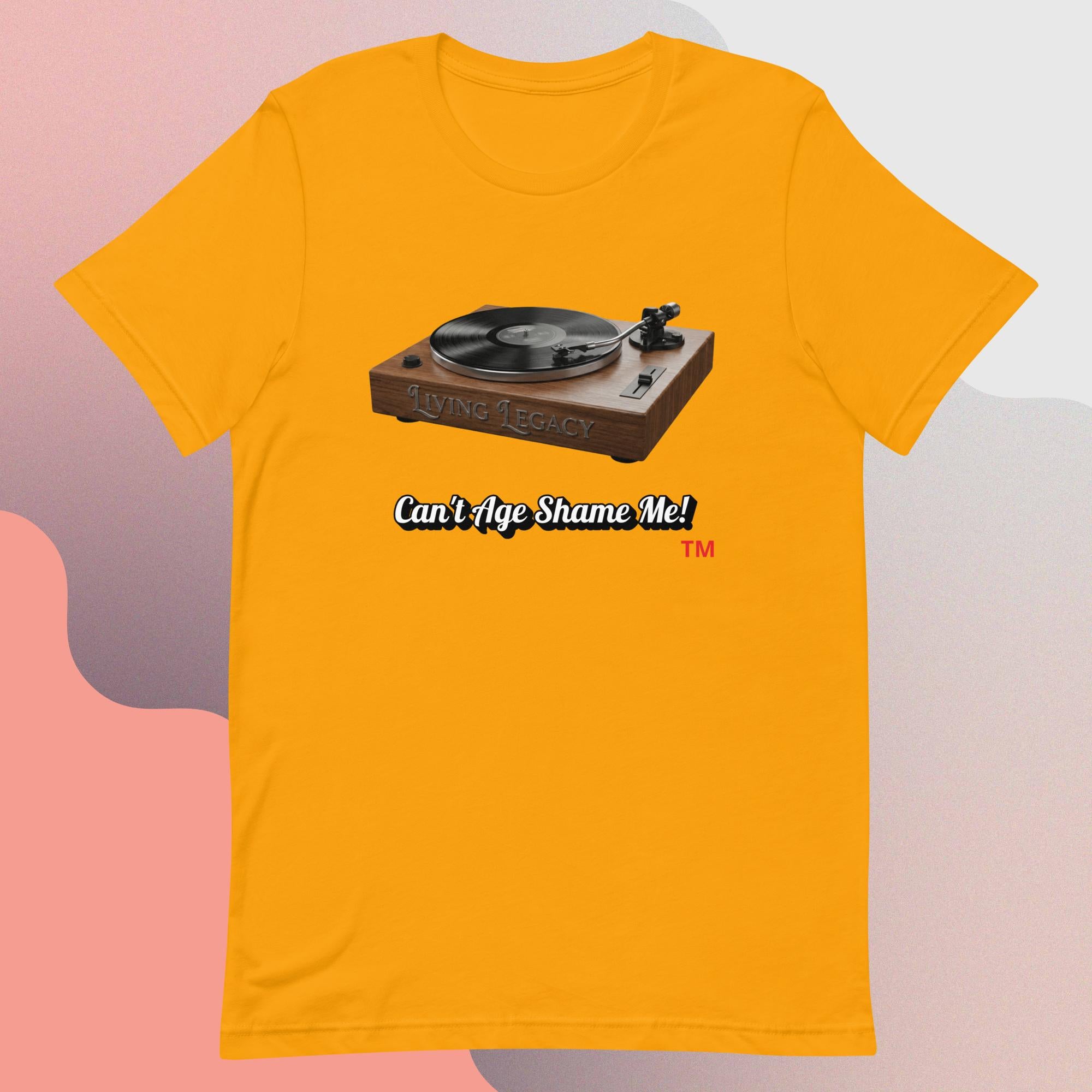 gold t-shirt with a graphic of a turntable and text 'Can't Age Shame Me!' on a gradient background.