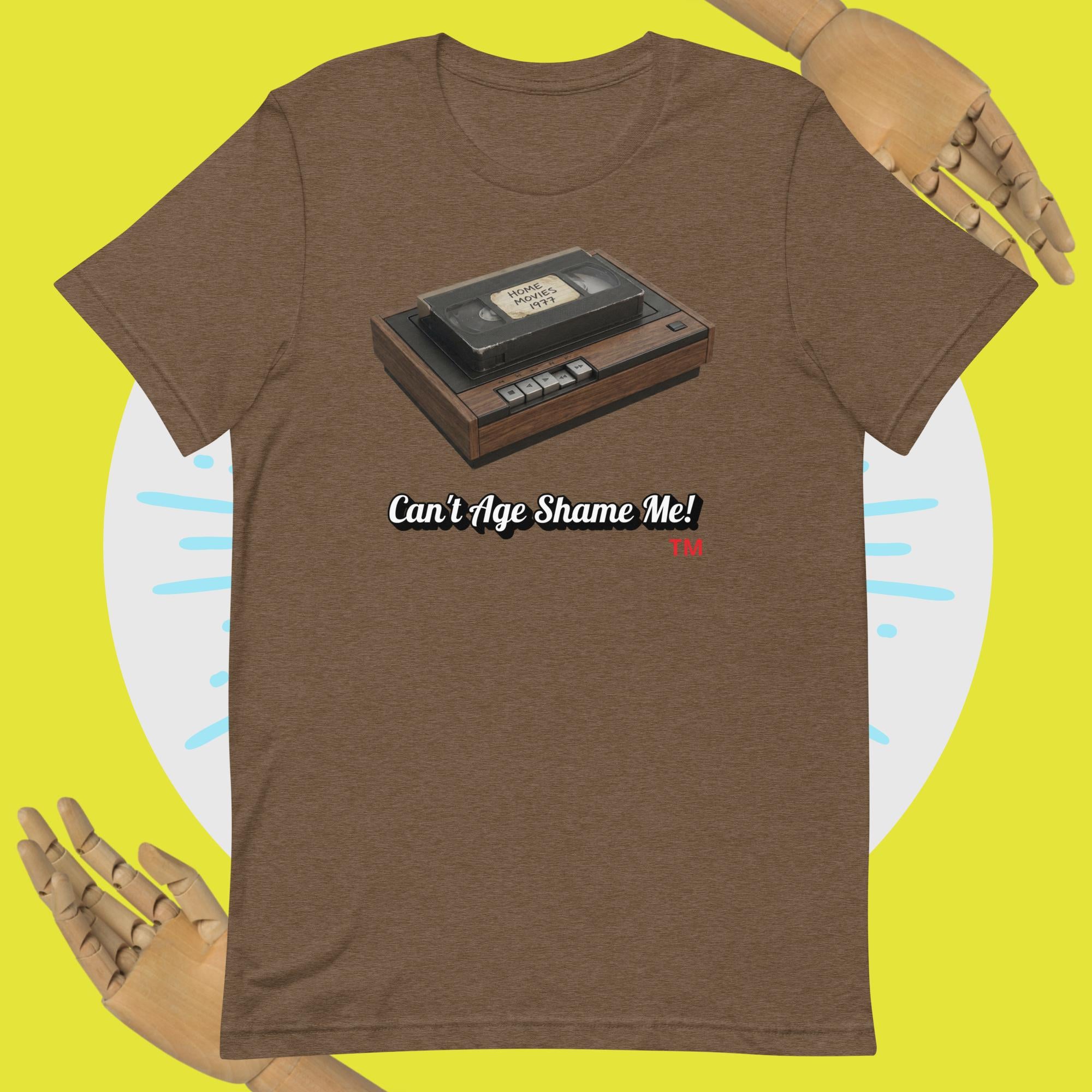 Brown t-shirt with a cassette tape graphic and 'Can't Age Shame Me!' text on a yellow background.