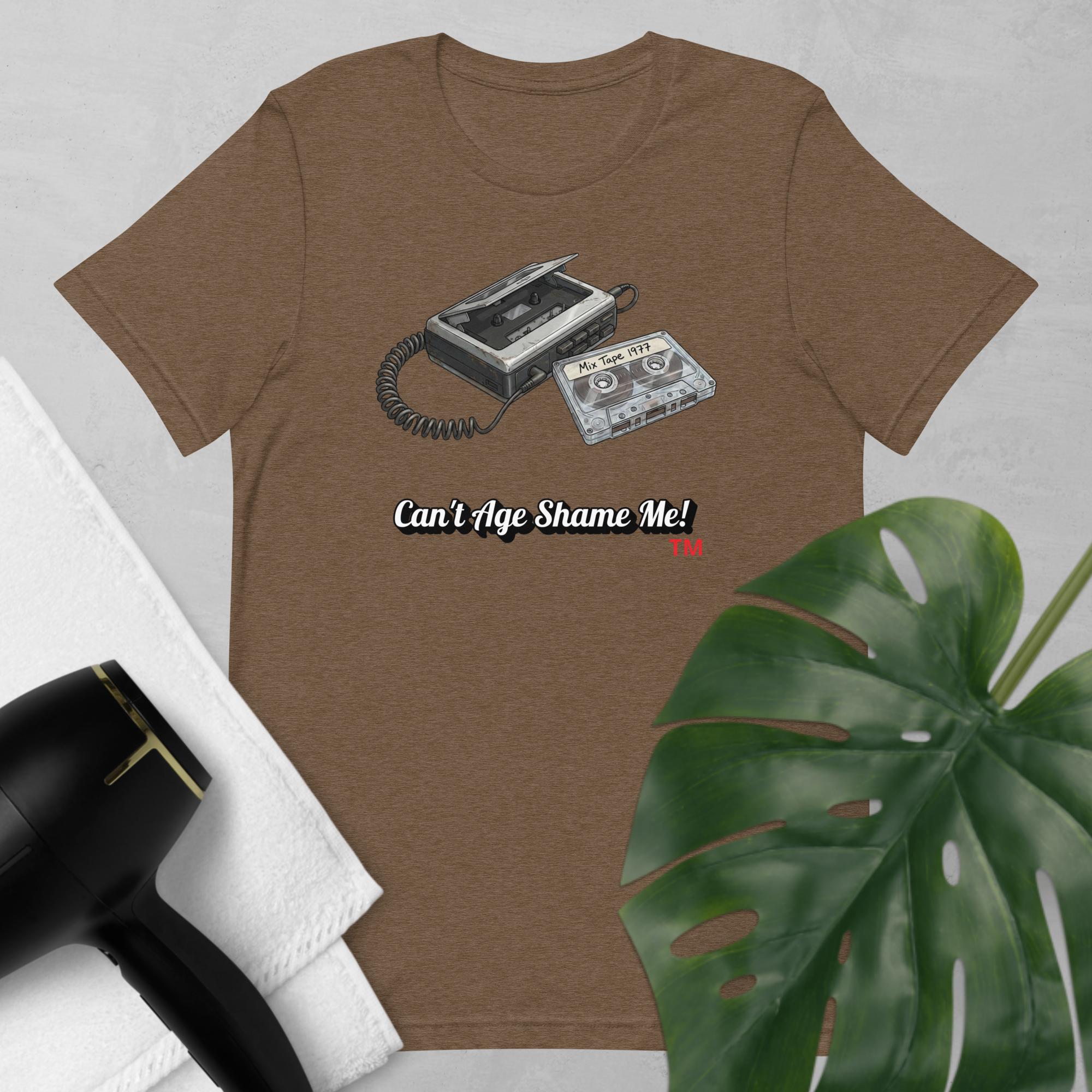 heather Brown t-shirt with a cassette tape graphic and text 'Can't Age Shame Me!' on a light gray background.
