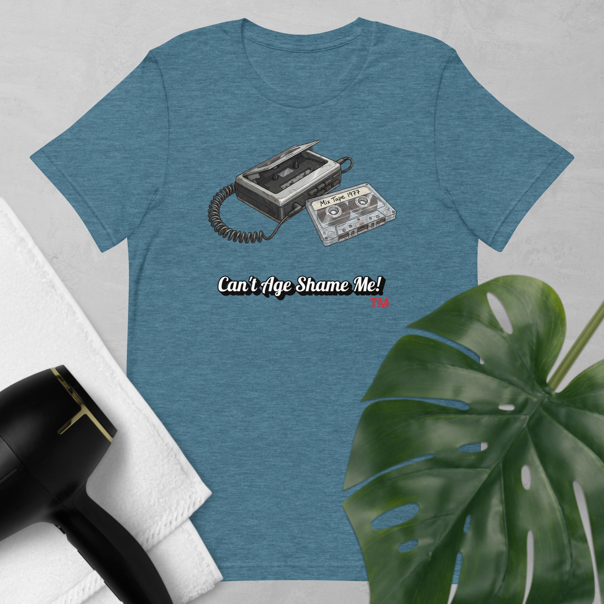 heather teal  t-shirt with a graphic of a cassette tape and text 'Can't Age Shame Me!' on a light gray background.