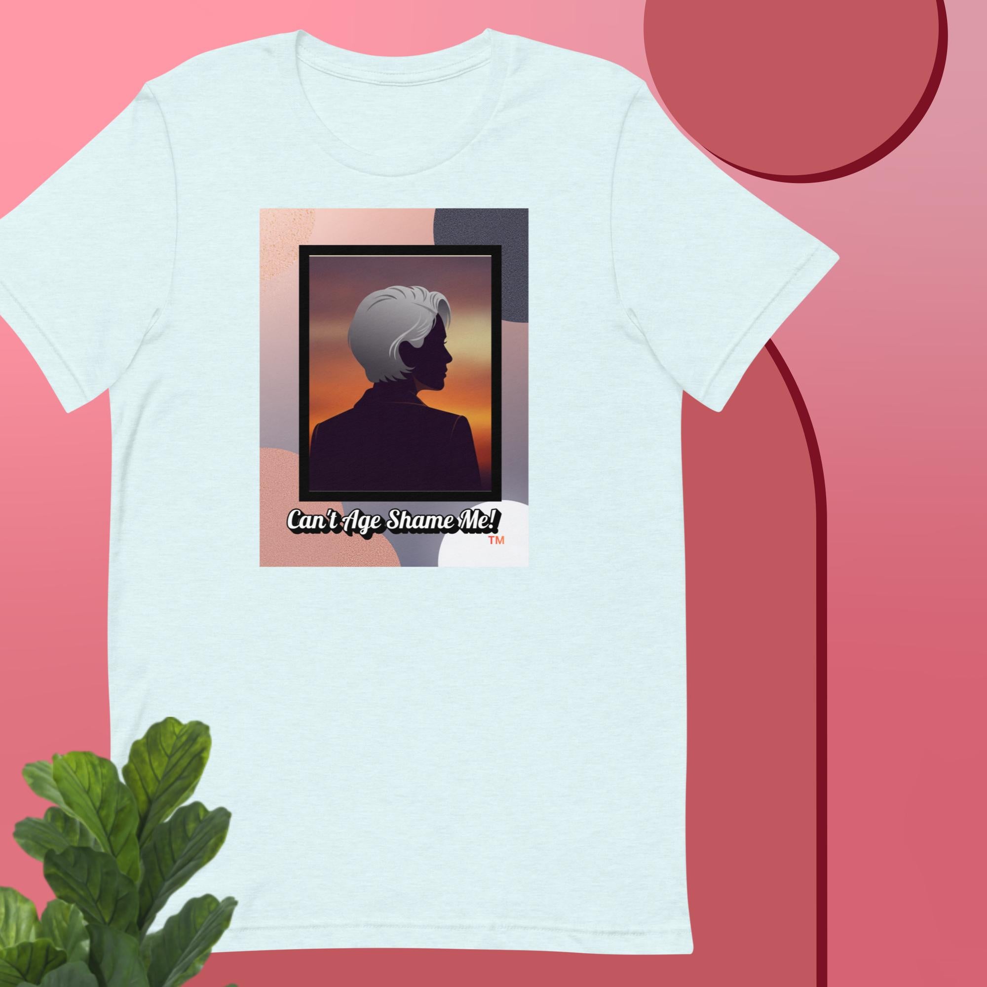 Ice Blue t-shirt with a graphic design featuring a woman with gray hair silhouette and text: Can’t Age Shame Me! on a pink background.


