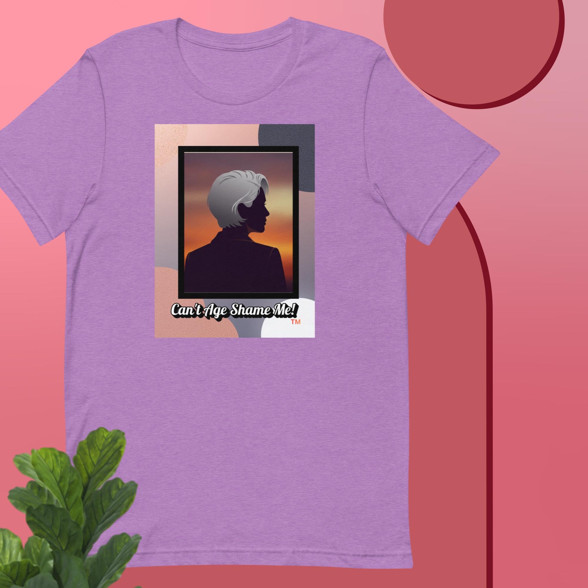 Heather Purple t-shirt with a graphic design featuring a woman with gray hair silhouette and text: Can’t Age Shame Me! on a pink background.


