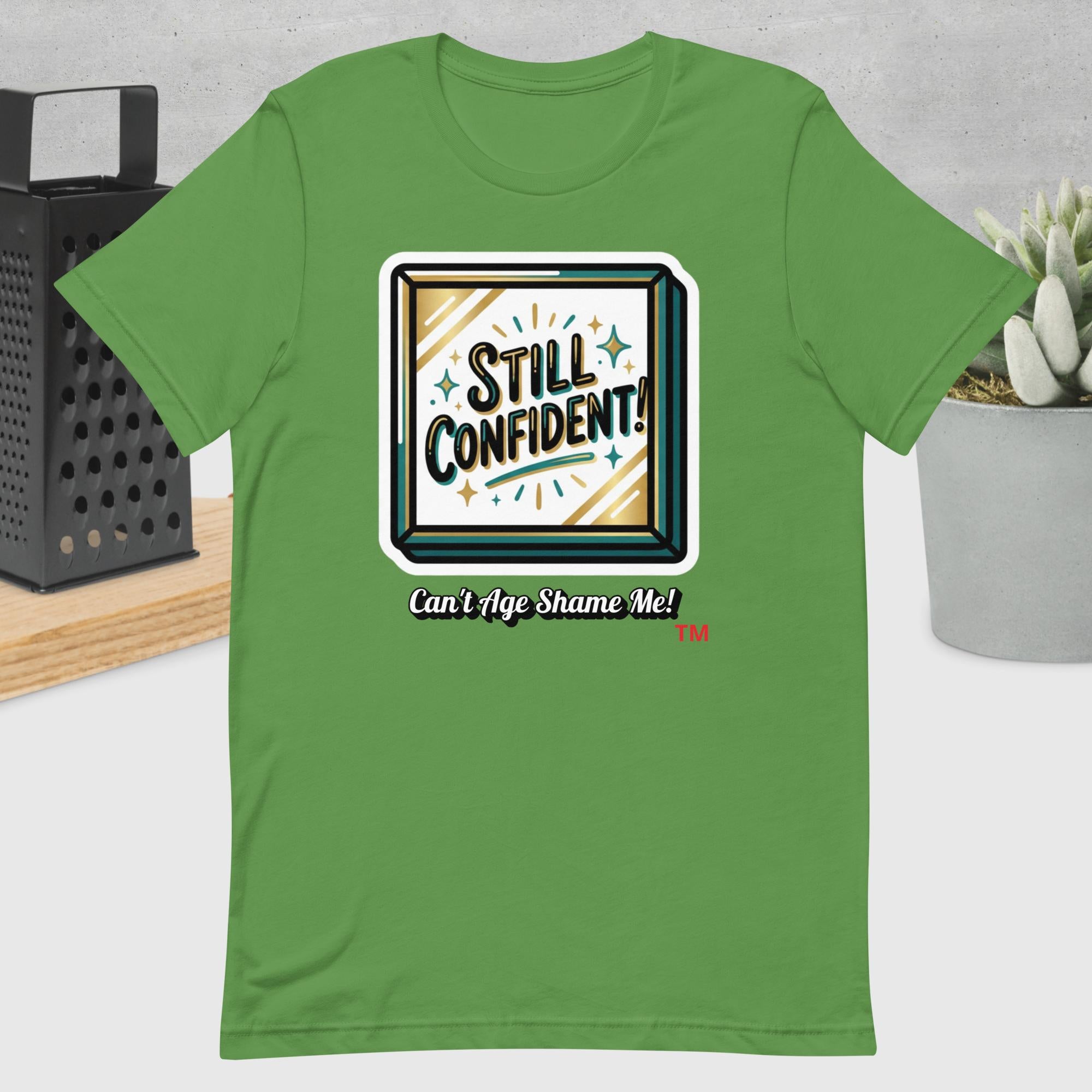 Leaf  t-shirt with 'Still Confident! Can't Age Shame Me!' design on a neutral background