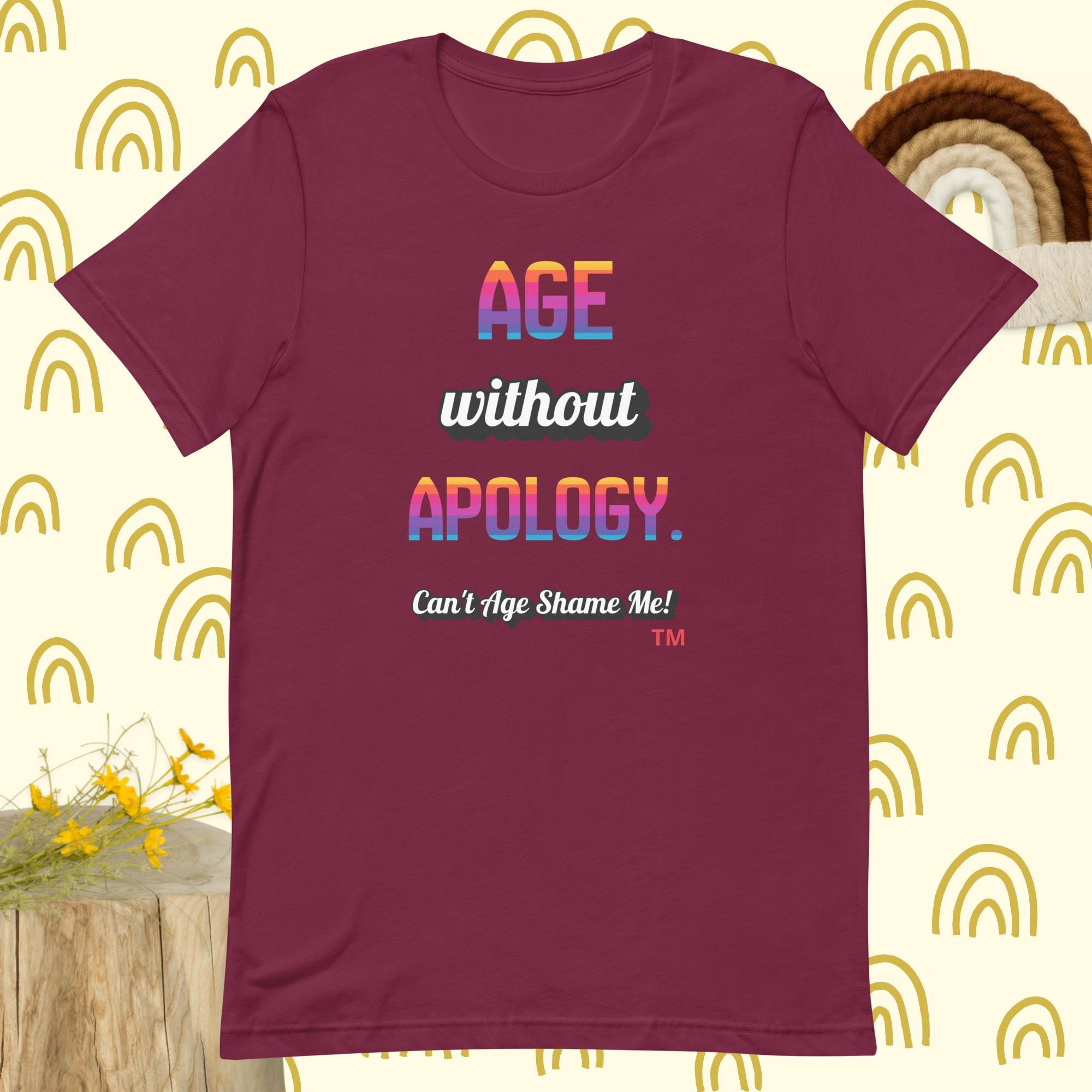 Maroon t-shirt with colorful text on a patterned background