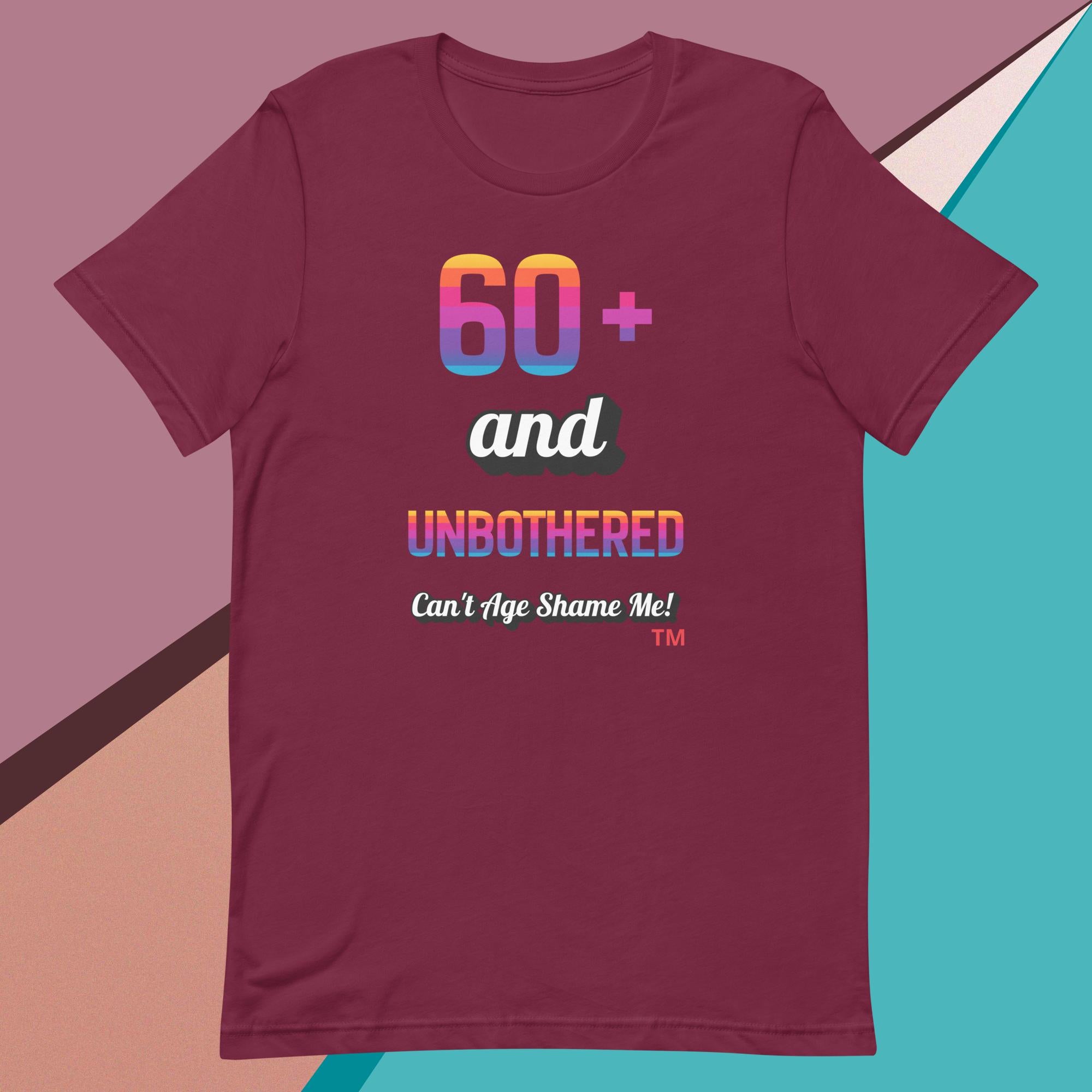 Maroon t-shirt with colorful text design on a geometric background