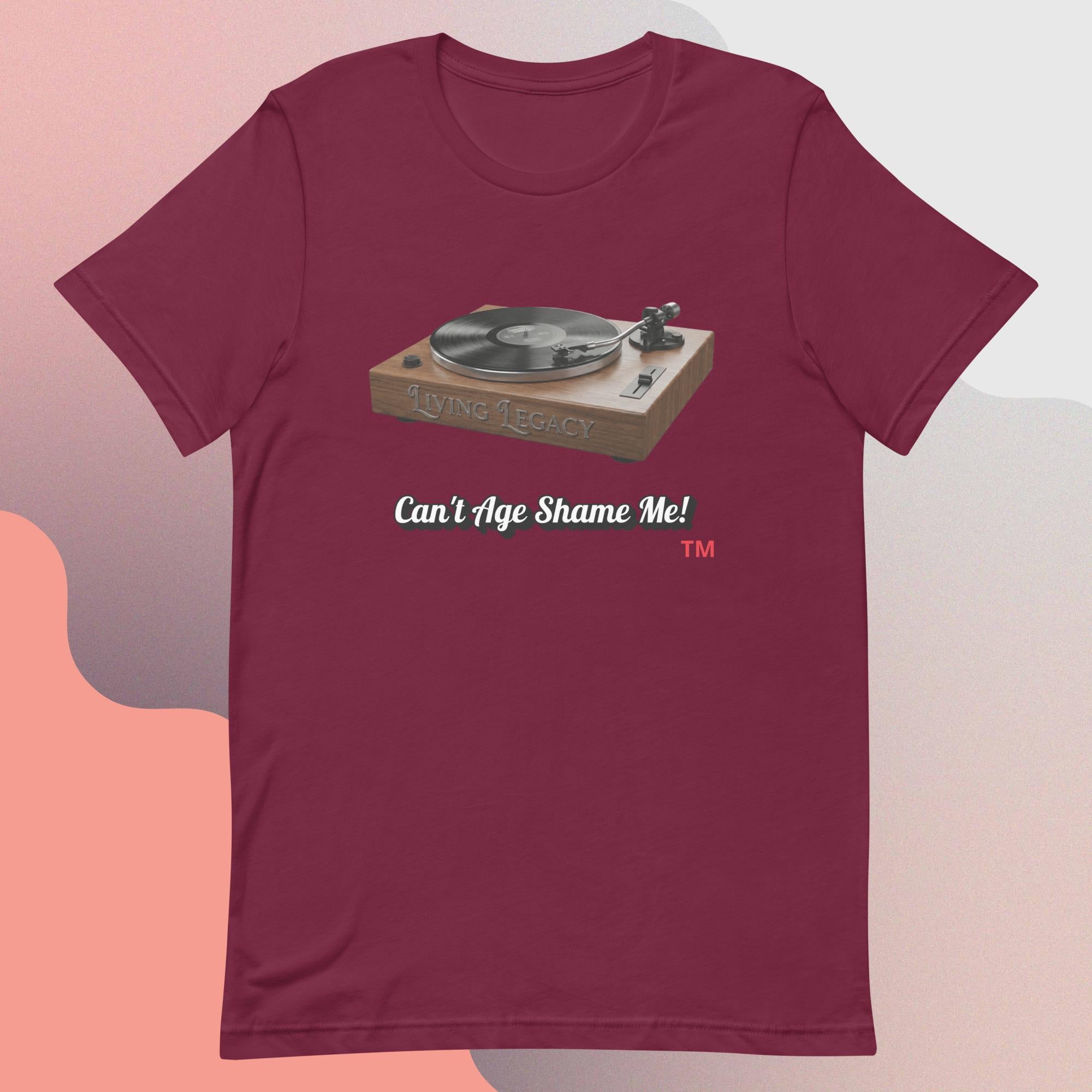 maroon t-shirt with a graphic of a turntable and text 'Can't Age Shame Me!' on a gradient background.