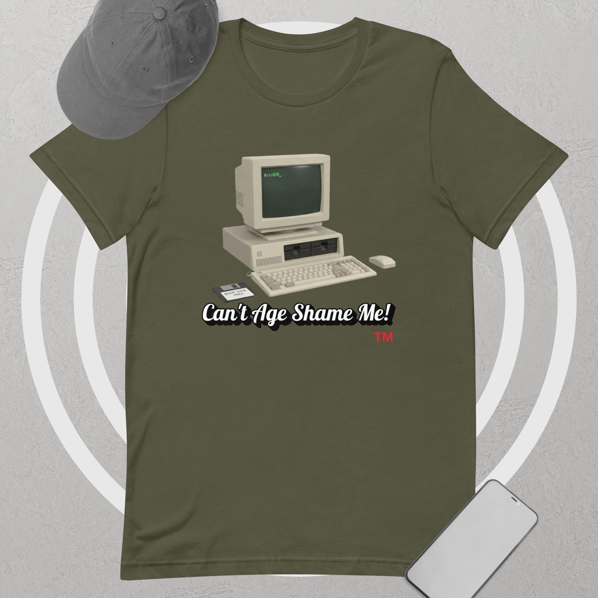 military Green t-shirt with vintage computer graphic and text 'Can't Age Shame Me! I'm 1995' on a gray background.