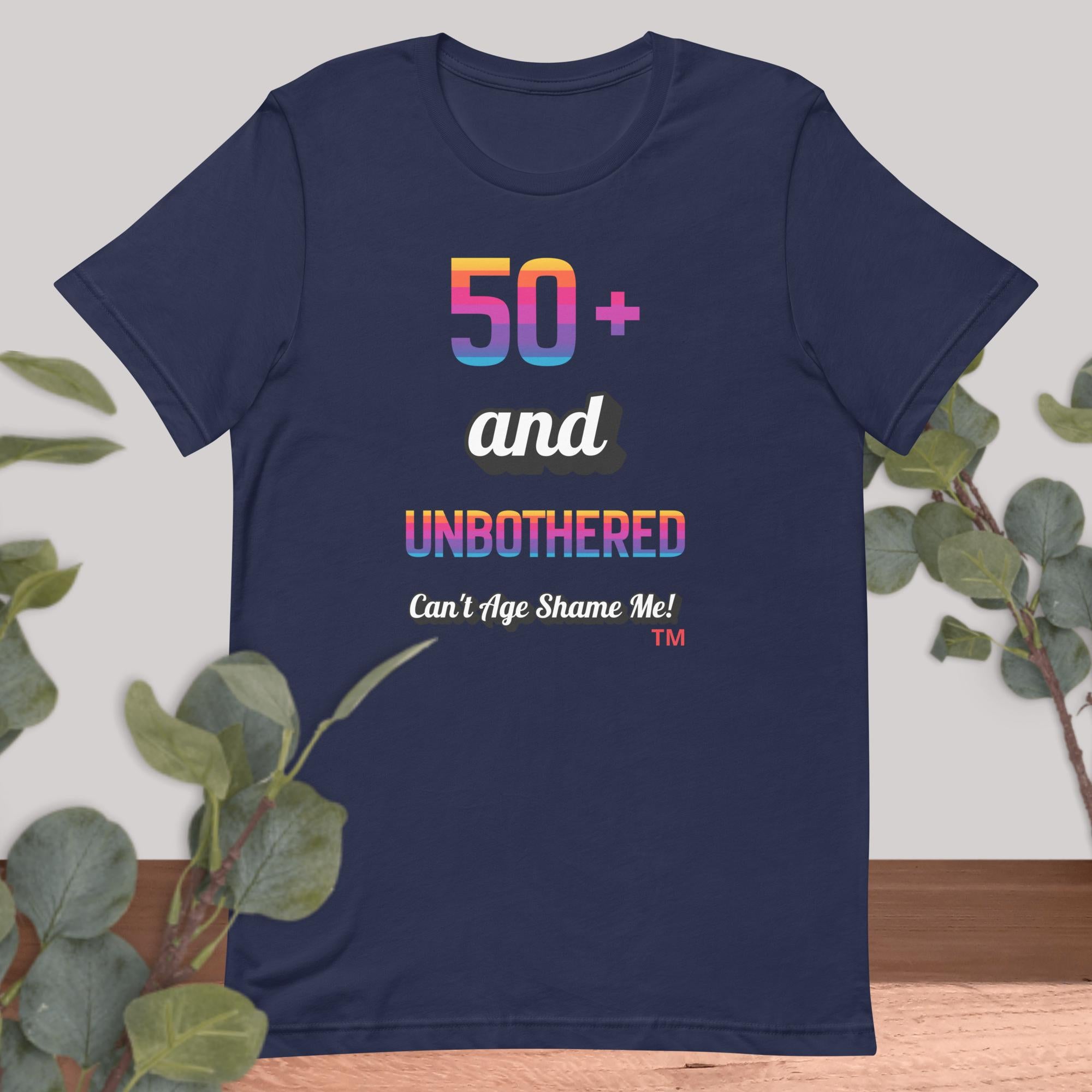 Navy blue t-shirt with colorful text design on a light gray background with green leaves.