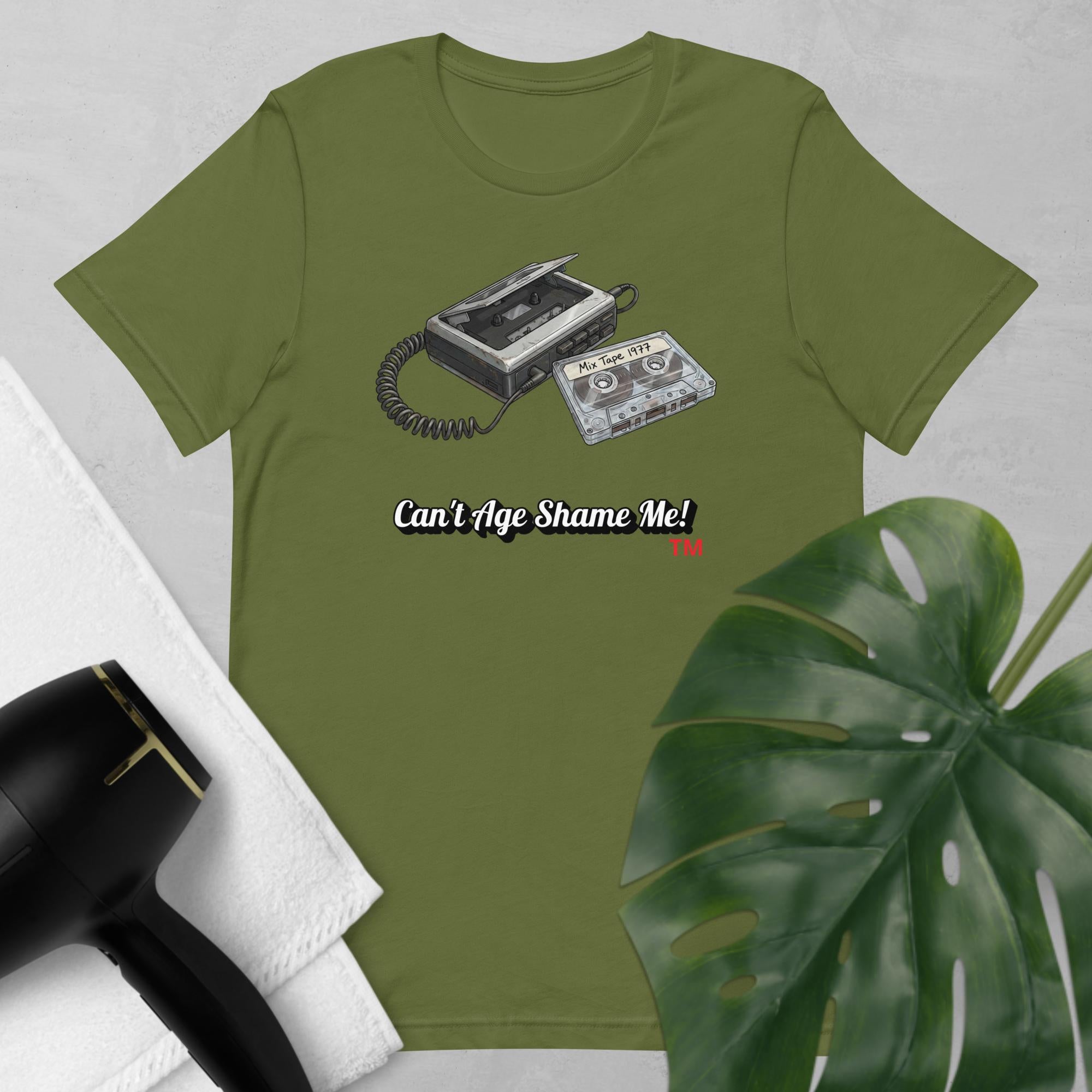 olive  t-shirt with cassette tape design and text 'Can't Age Shame Me!' on a light gray background.