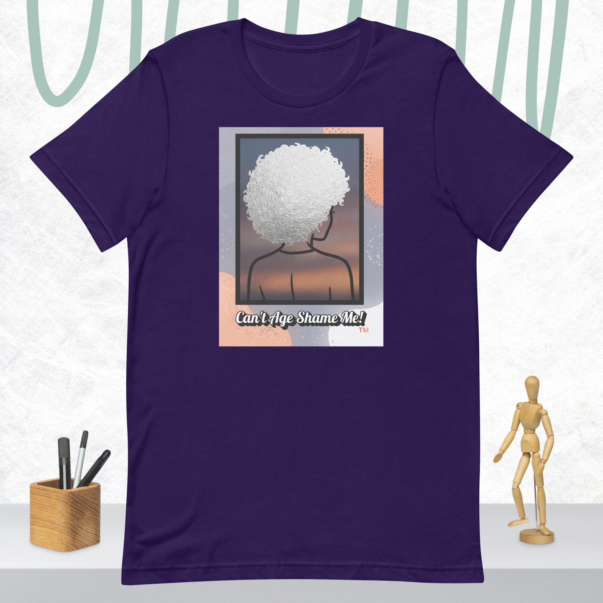 Purple  t-shirt with a graphic of a person with an afro and text 'Can't Age Shame Me!' on a white background.