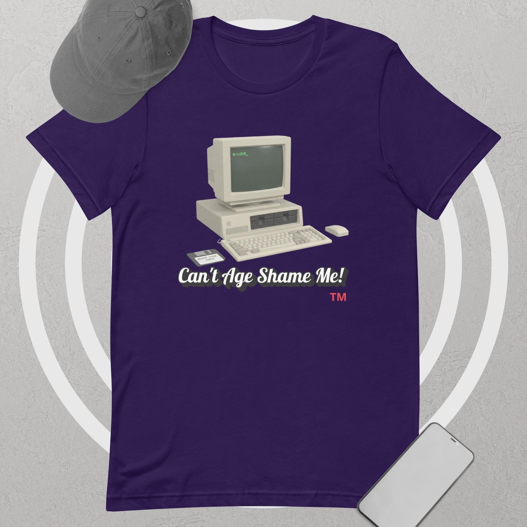 Purple t-shirt with a vintage computer graphic and text 'Can't Age Shame Me!' on a gray background.