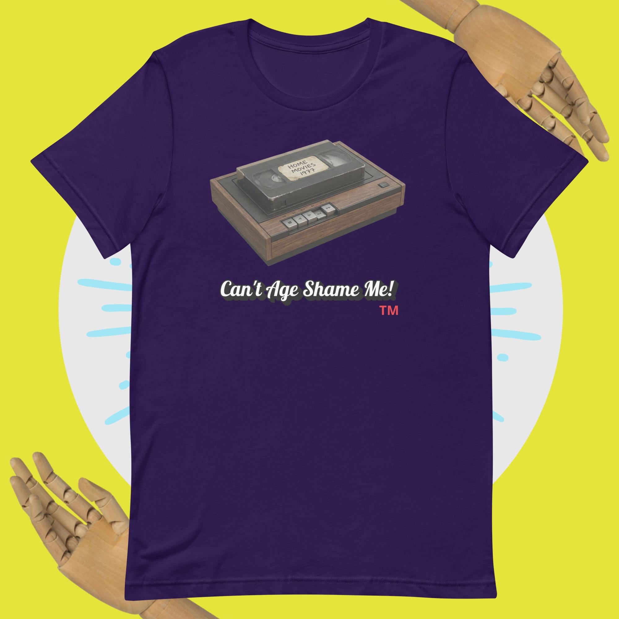 Purple t-shirt with a cassette tape graphic and text 'Can't Age Shame Me!' on a yellow background.