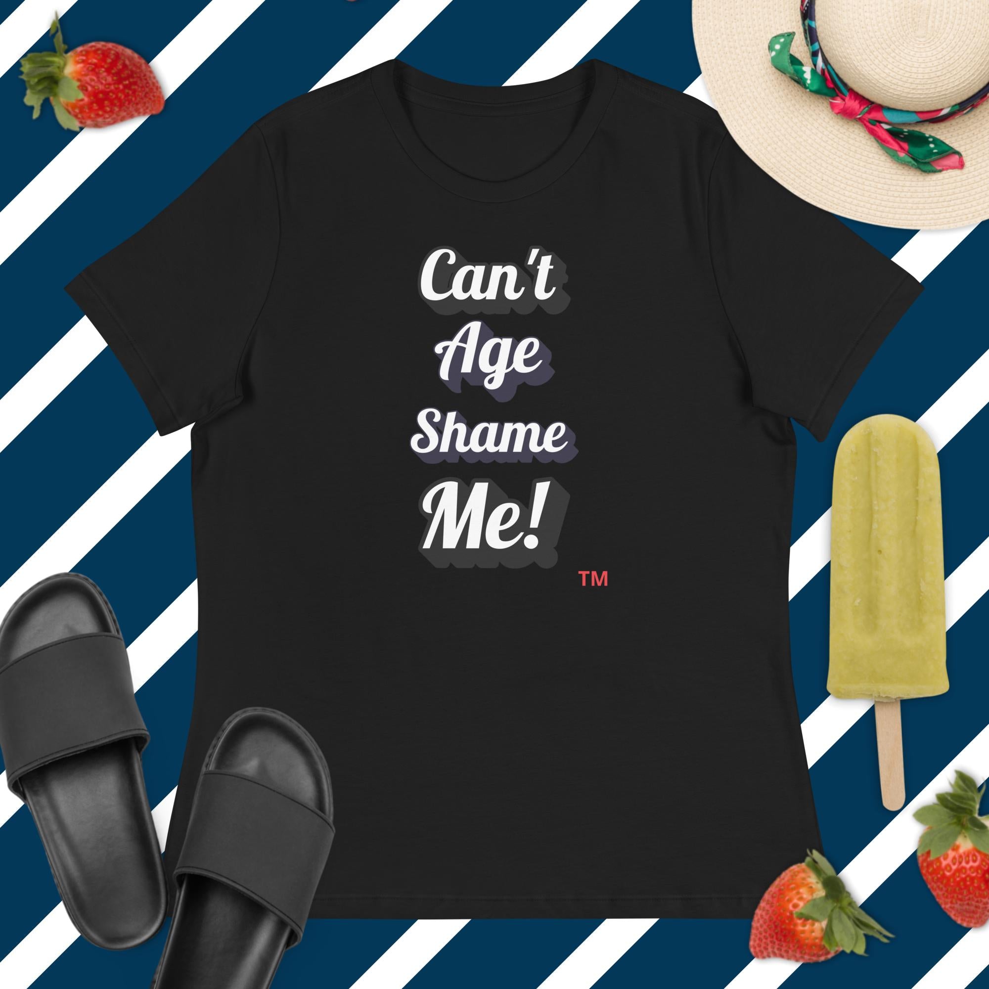 Black t-shirt with 'Can't Age Shame Me!' text on a blue and white striped background with accessories.