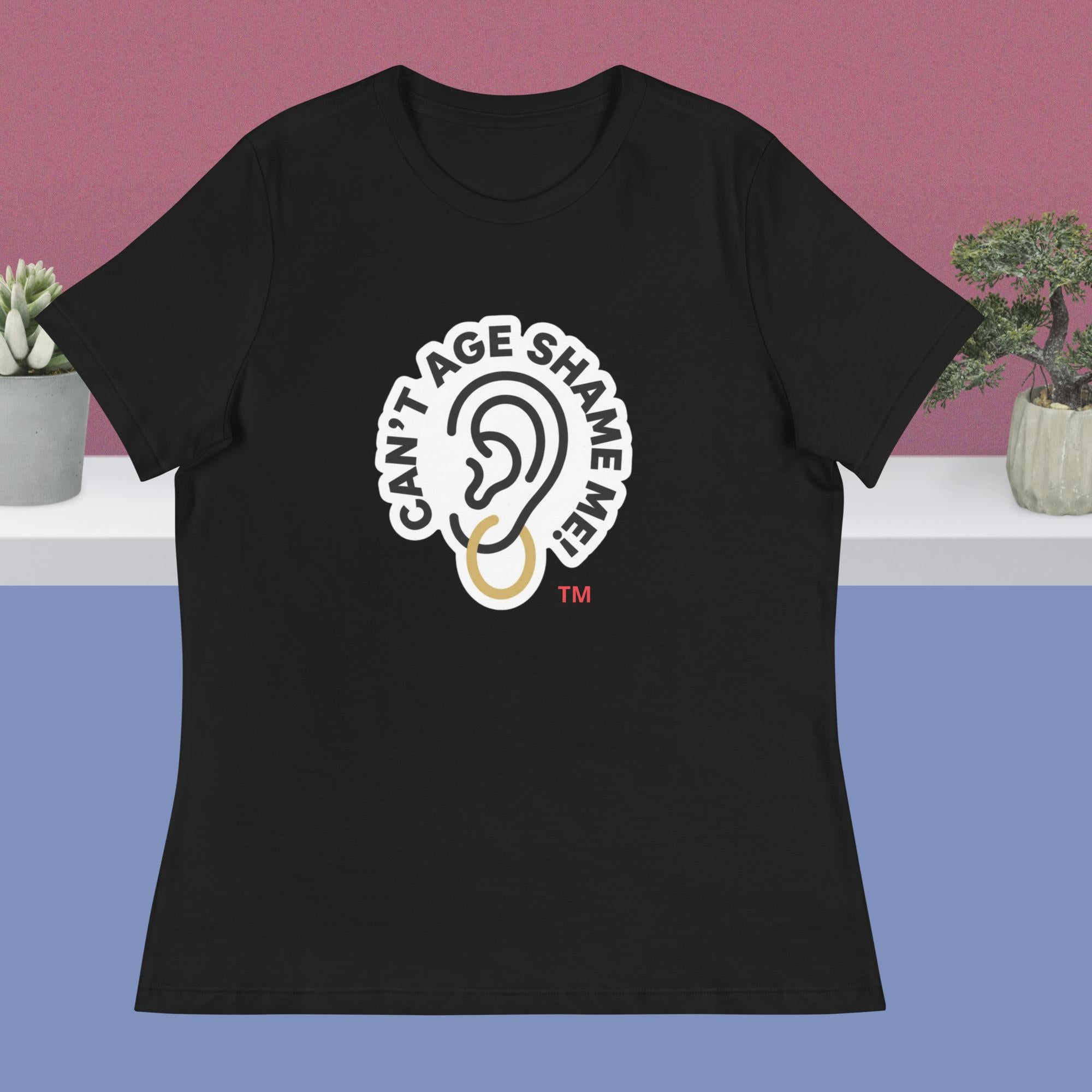 Black t-shirt with 'Can't Age Shame Me' graphic on a blue and pink gradient background