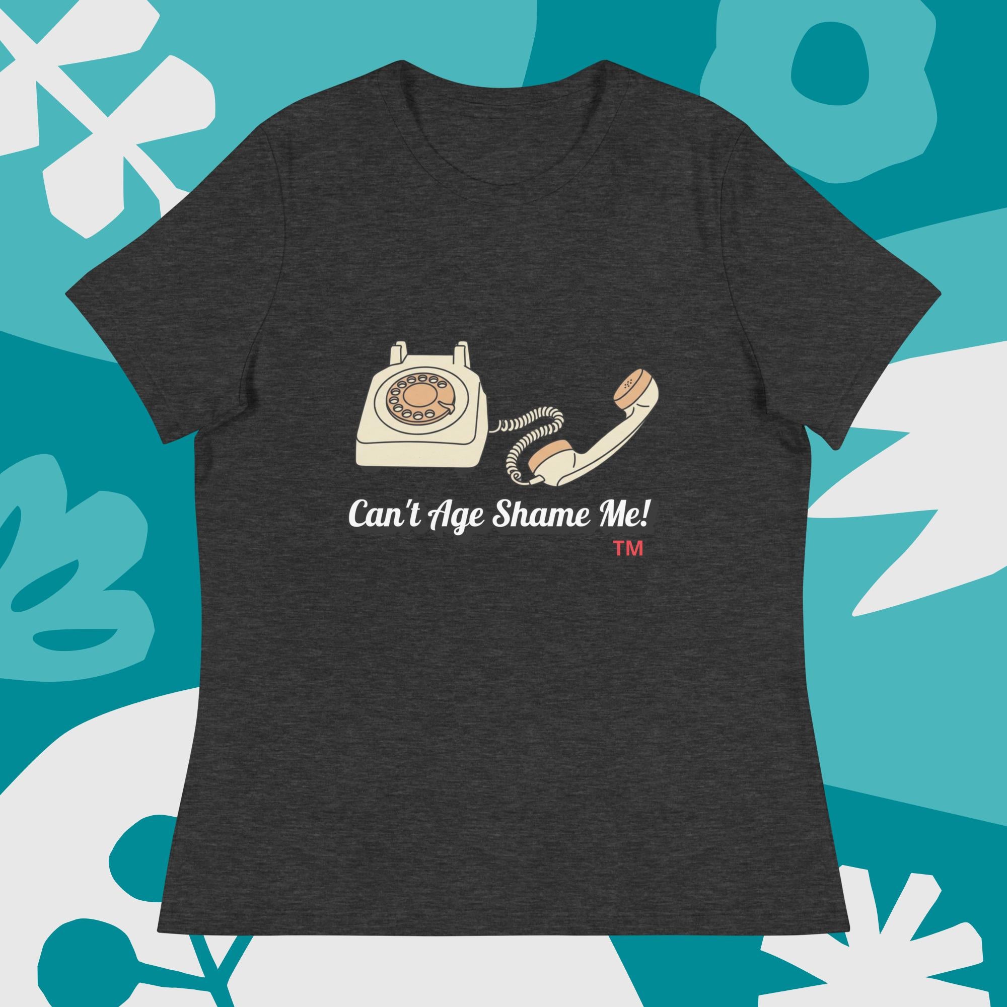Dark gray t-shirt with vintage phone graphic and 'Can't Age Shame Me!' text on a blue and white abstract background.
