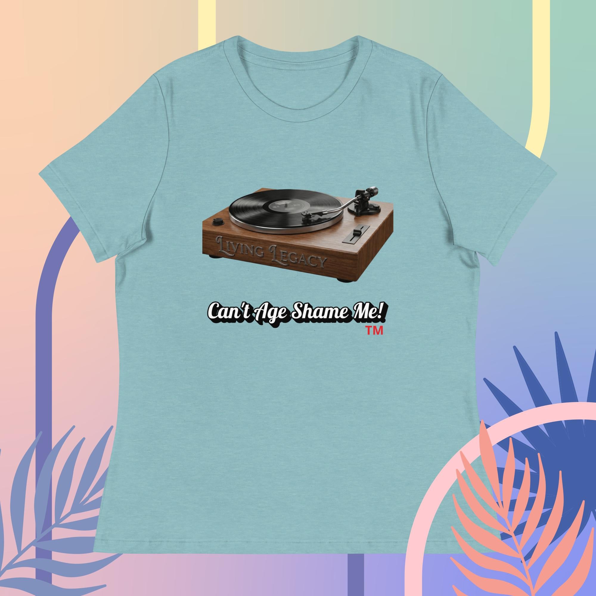 Light blue t-shirt with a graphic of a turntable and text 'Can't Age Shame Me!' on a colorful abstract background.