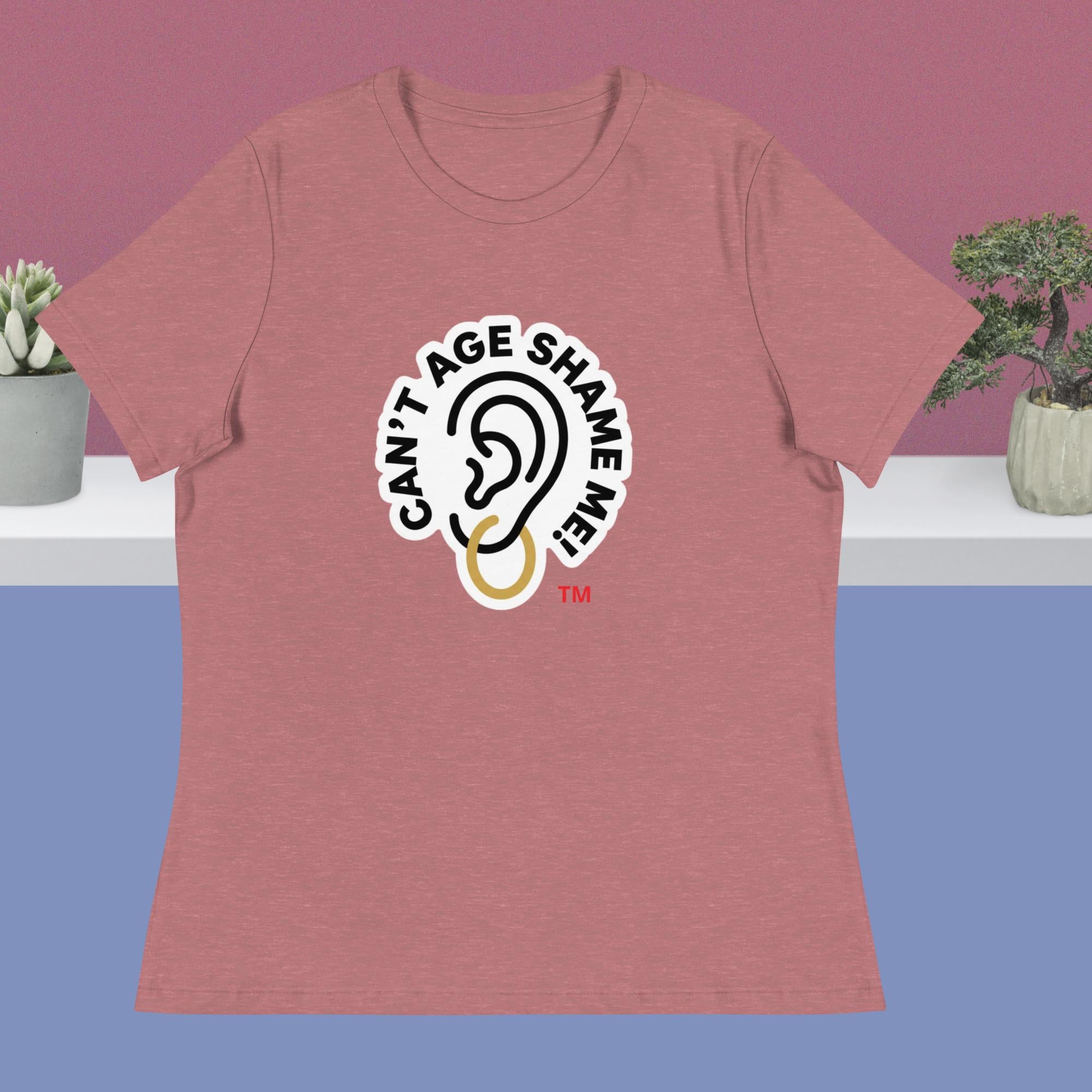 Mauve t-shirt with 'Can't Age Shame Me' logo on a purple and blue gradient background