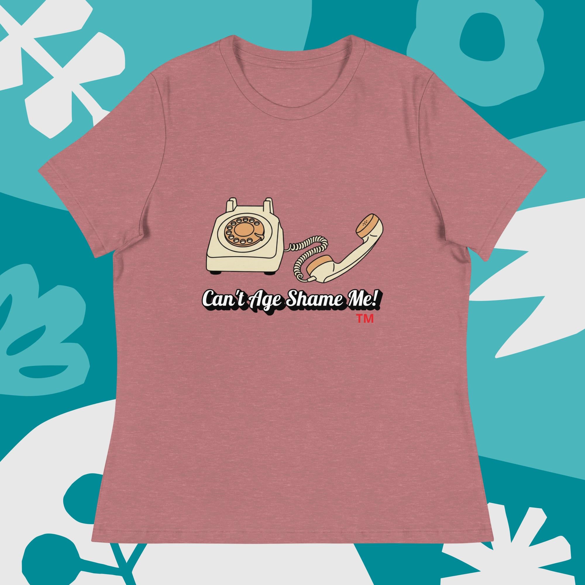 heather mauve t-shirt with vintage phone graphic and 'Can't Age Shame Me!' text on a blue and white abstract background.