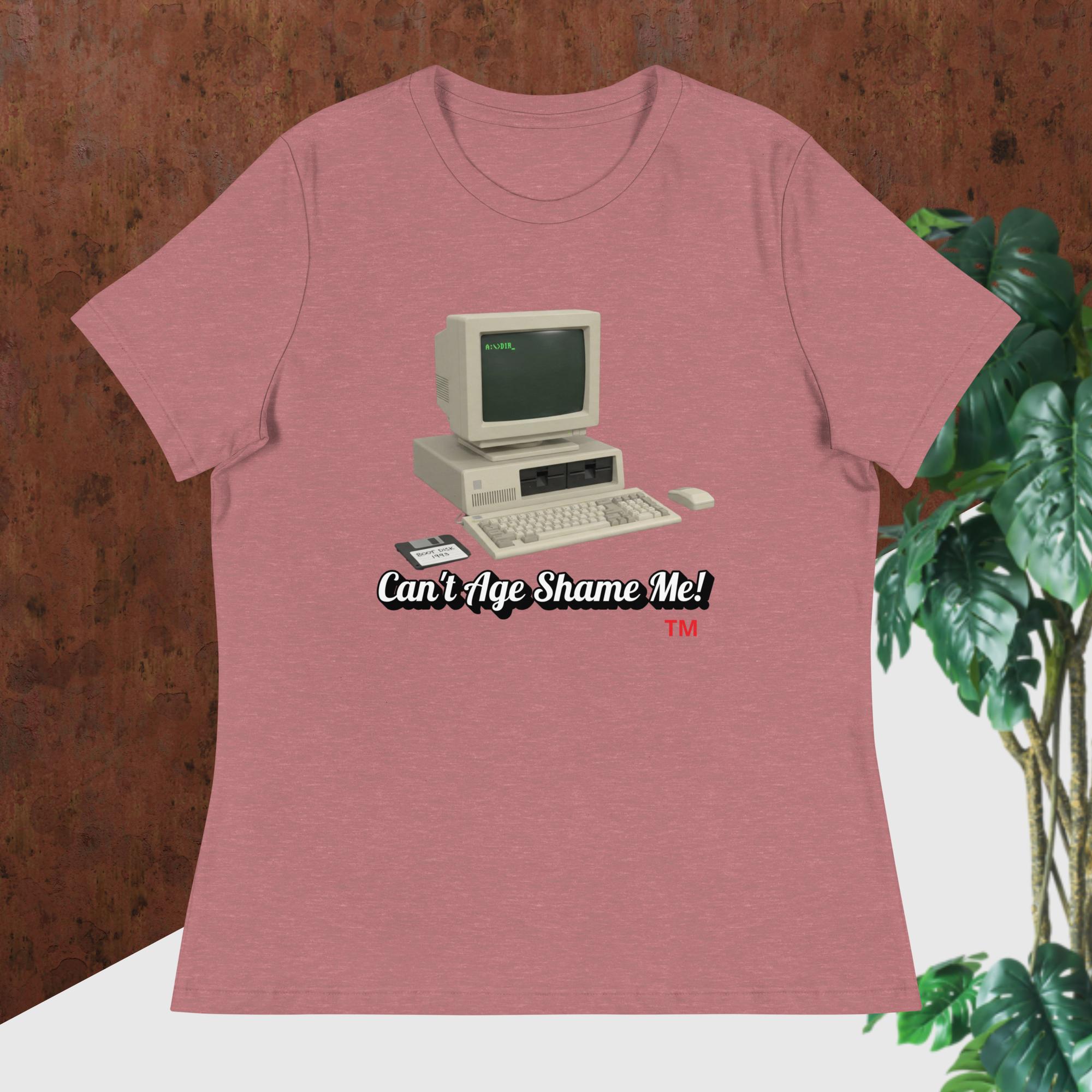 heather mauve t-shirt with vintage computer graphic and text 'Can't Age Shame Me!' on a wooden surface.