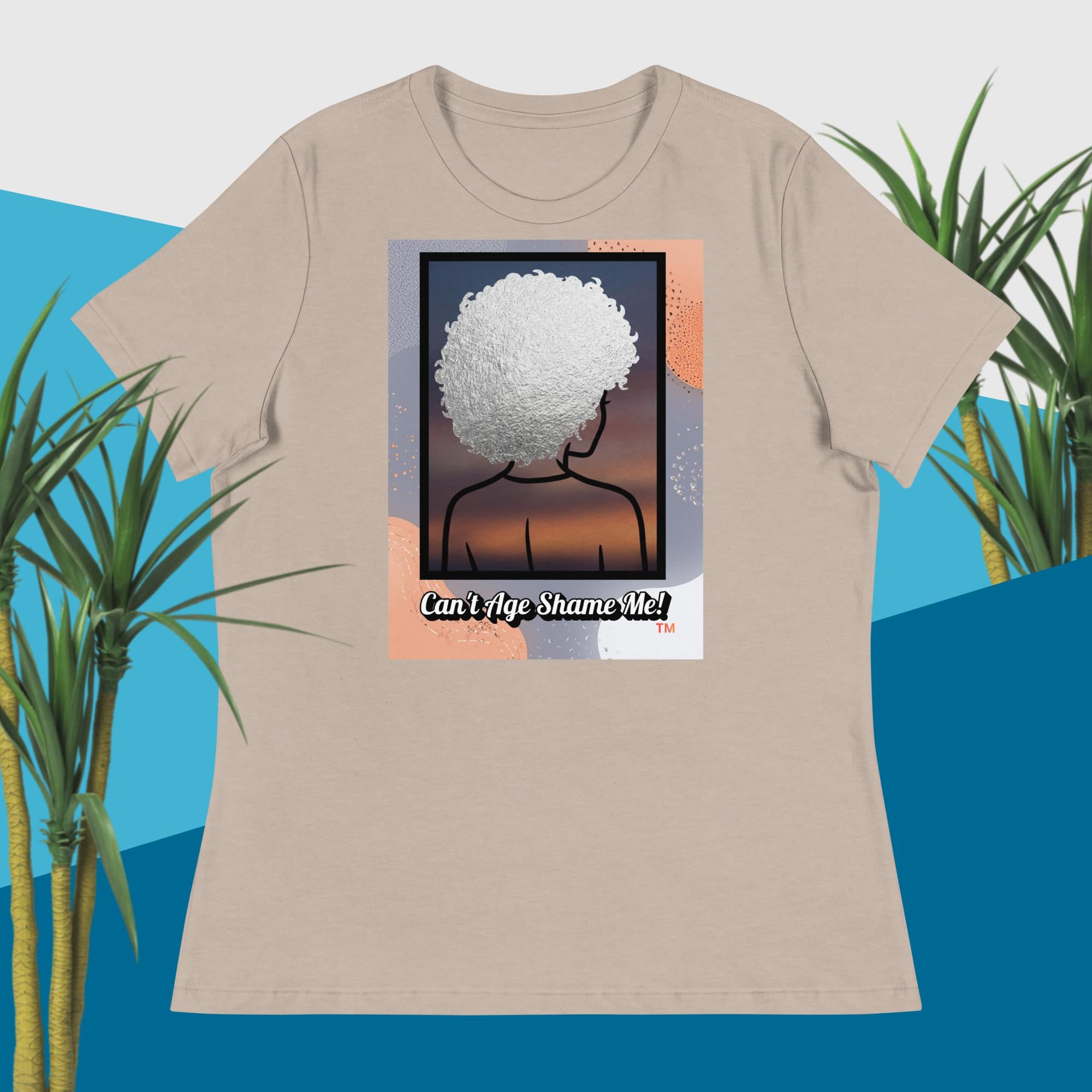 Light Gray t-shirt with a graphic design of a person with an afro and text 'Can't Age Shame Me!' on a blue and green plant background.