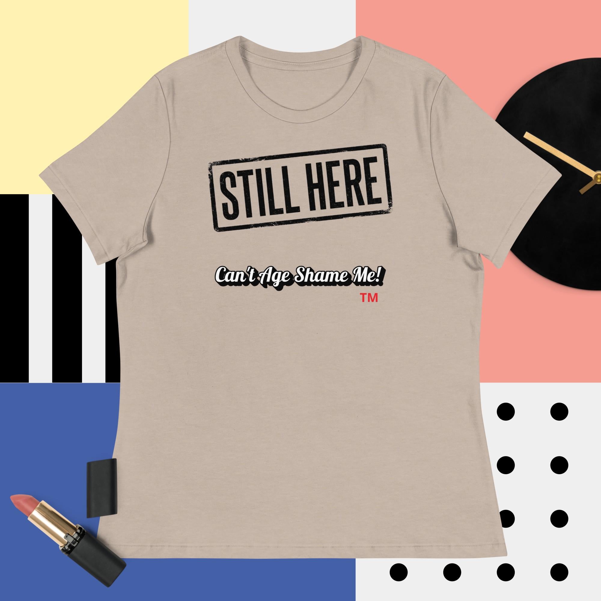 Heather Stone t-shirt with 'STILL HERE Can't Age Shame Me' text on a colorful background