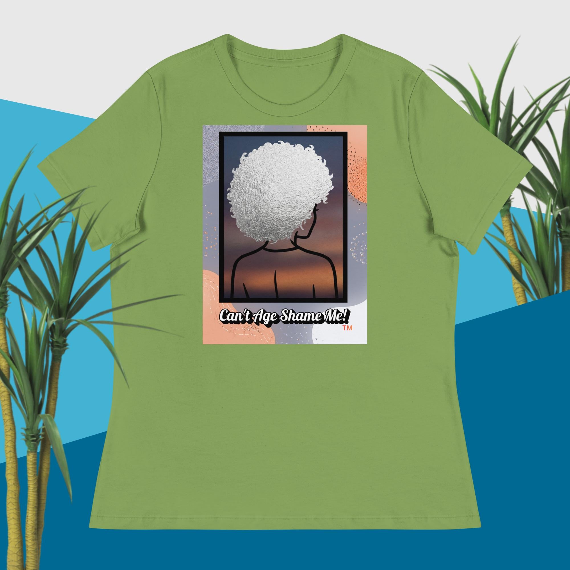 Green  t-shirt with a graphic design of a person with an afro and text 'Can't Age Shame Me!' on a blue and green plant background.