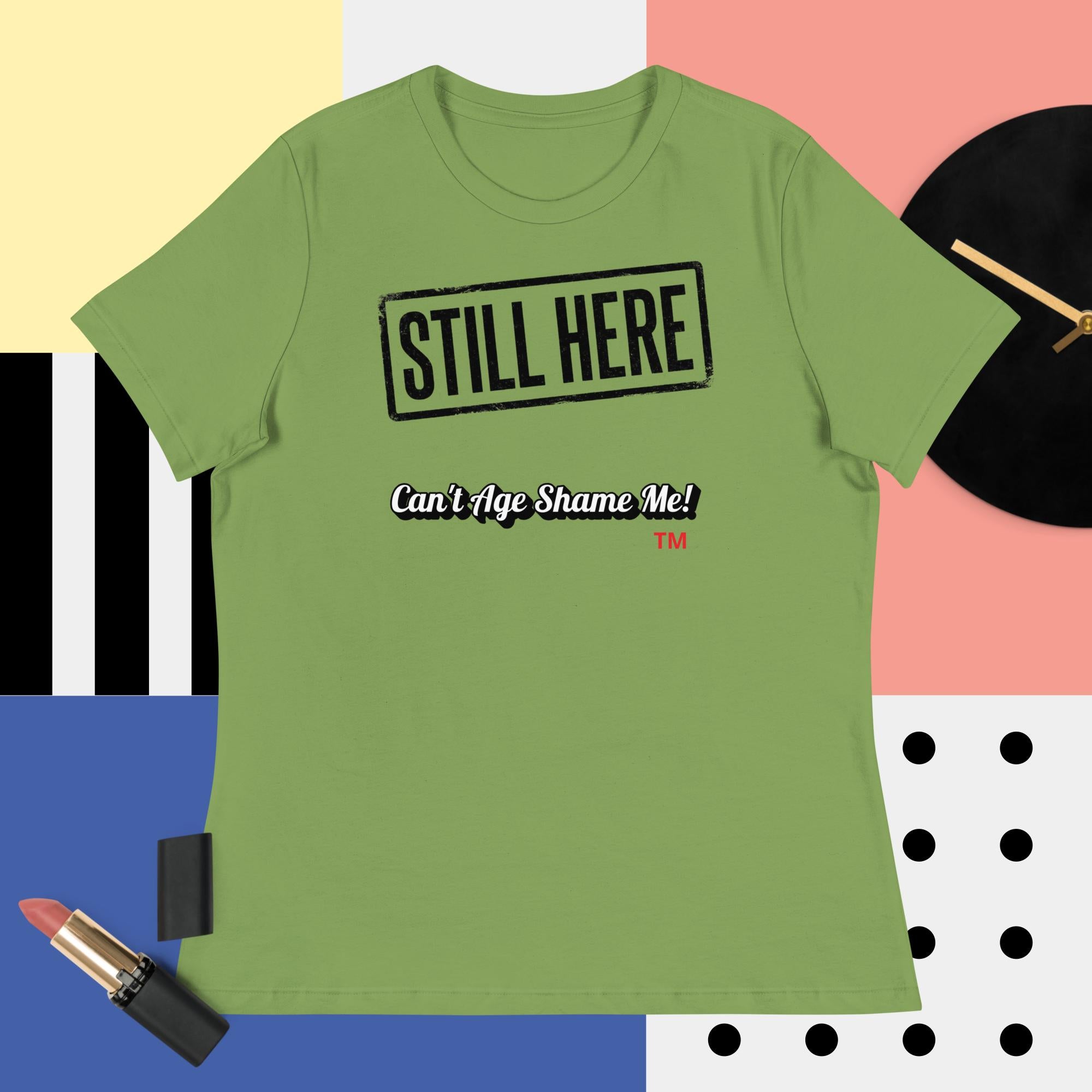 Green t-shirt with 'STILL HERE Can't Age Shame Me!' text on a colorful background