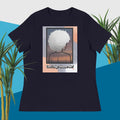 Dark Blue t-shirt with a graphic design of a person with an afro and text 'Can't Age Shame Me!' on a blue and green plant background.