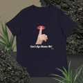 Navy t-shirt with graphic design of finger on mouth and text 'Can't Age Shame Me' on a textured surface with plants.