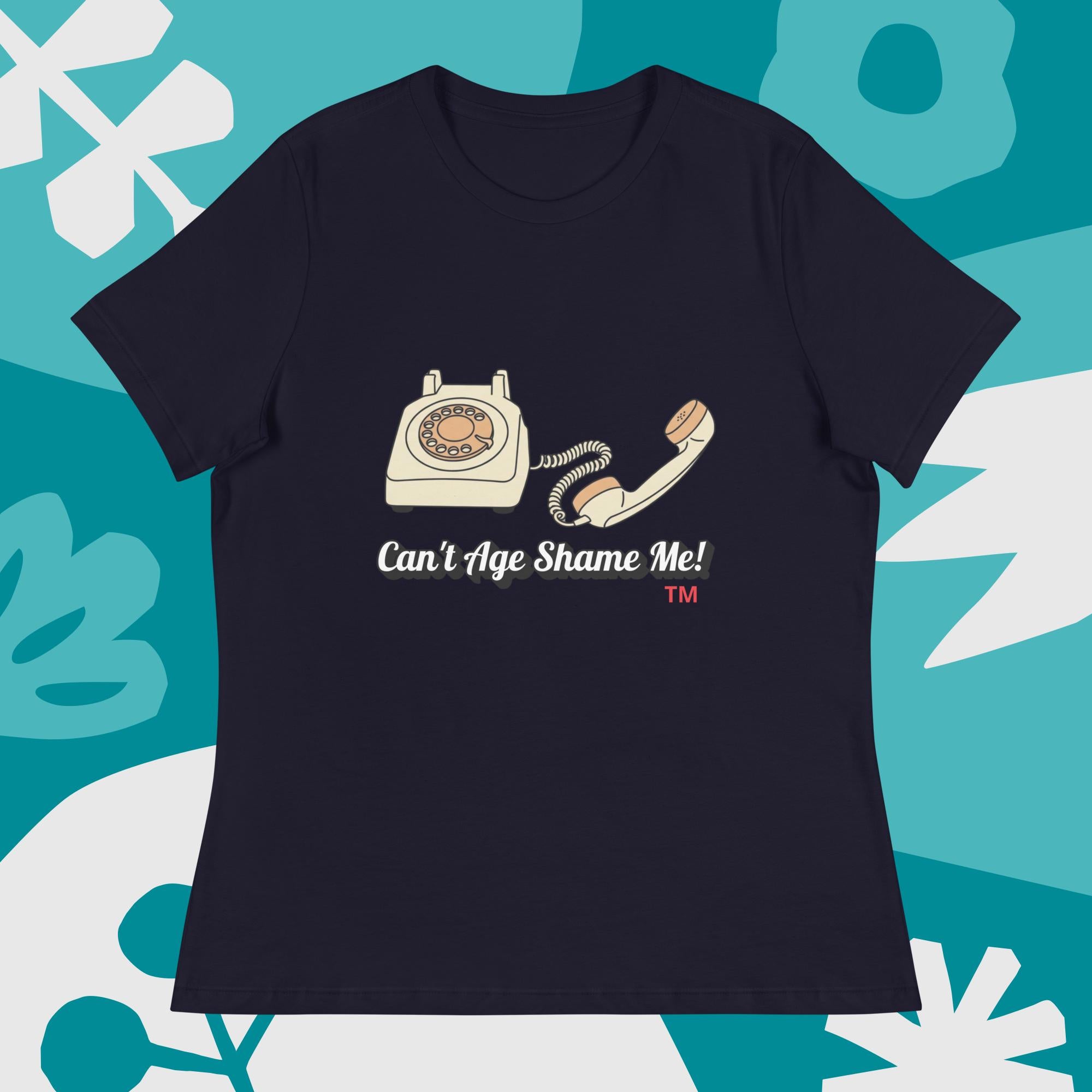 navy t-shirt with vintage phone graphic and 'Can't Age Shame Me!' text on a blue and white abstract background.