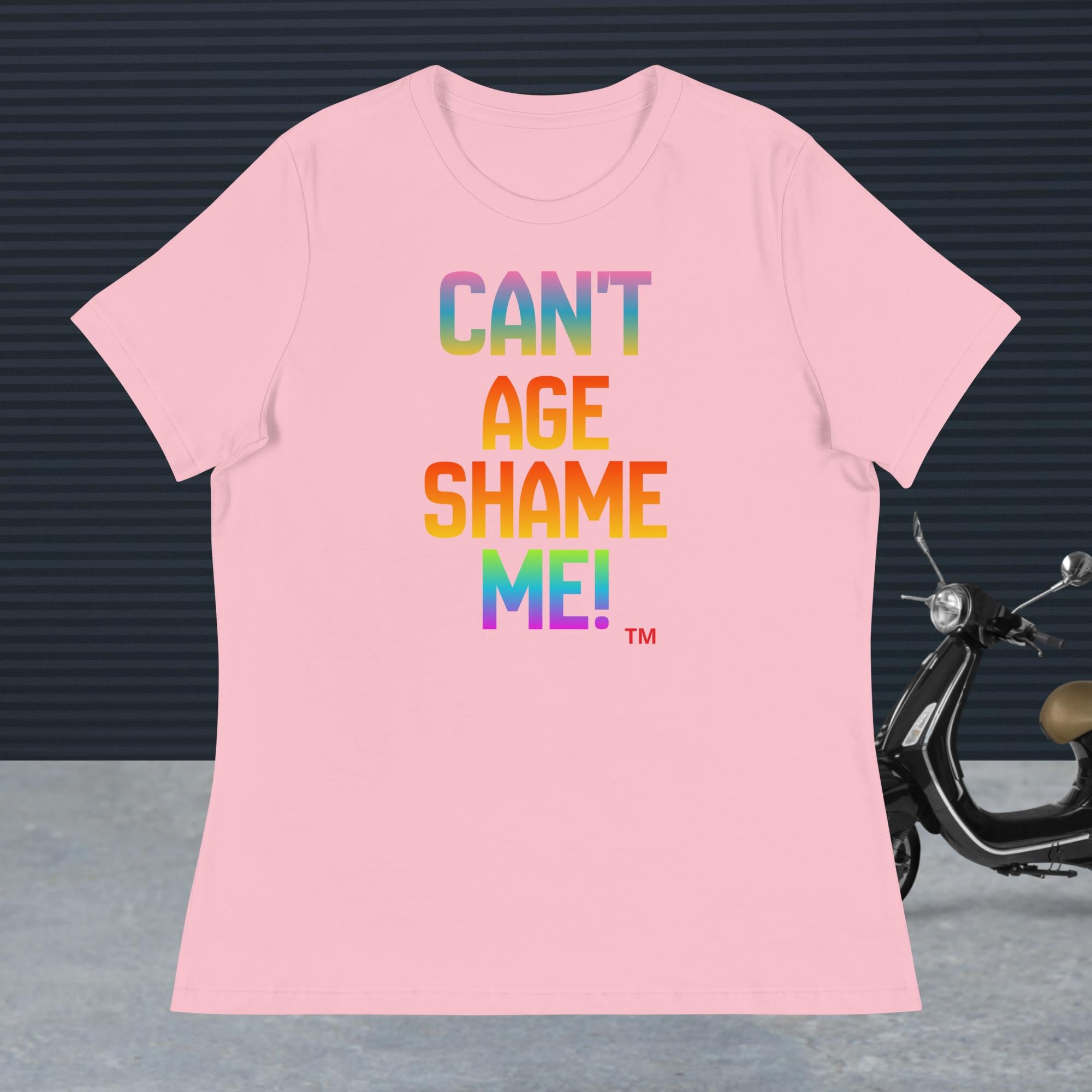 Pink t-shirt with colorful text 'CAN'T AGE SHAME ME!' on a dark background with a scooter.