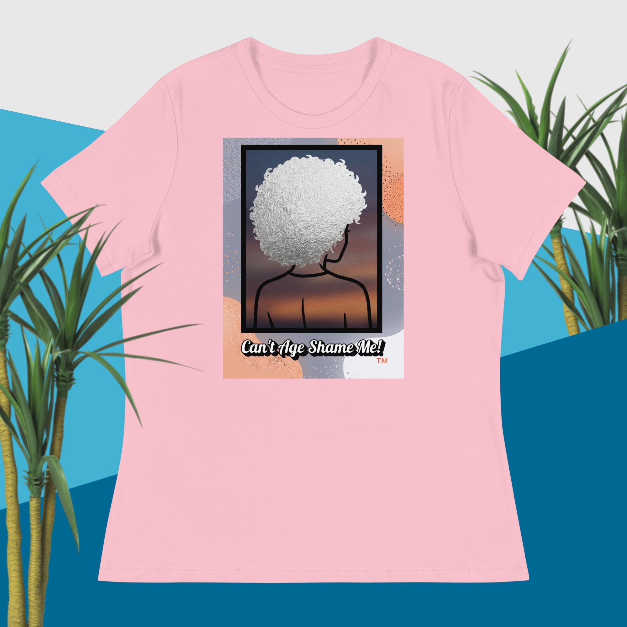 Pink t-shirt with a graphic design of a person with an afro and text 'Can't Age Shame Me!' on a blue and green plant background.