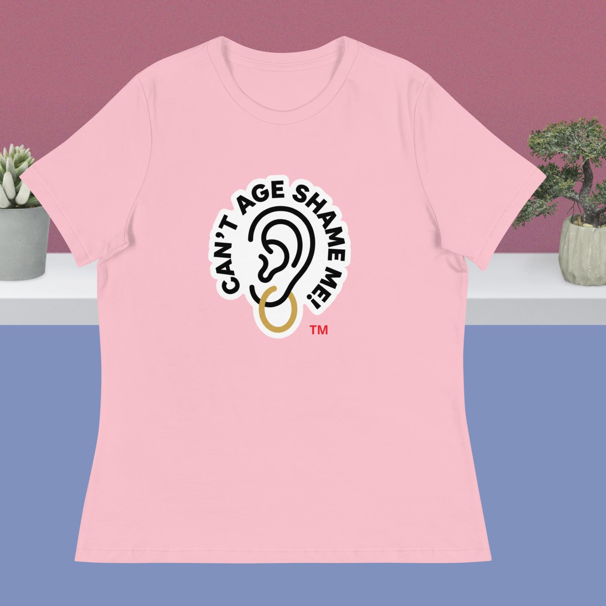 Pink t-shirt with 'Can't Age Shame Me' logo on a purple background
