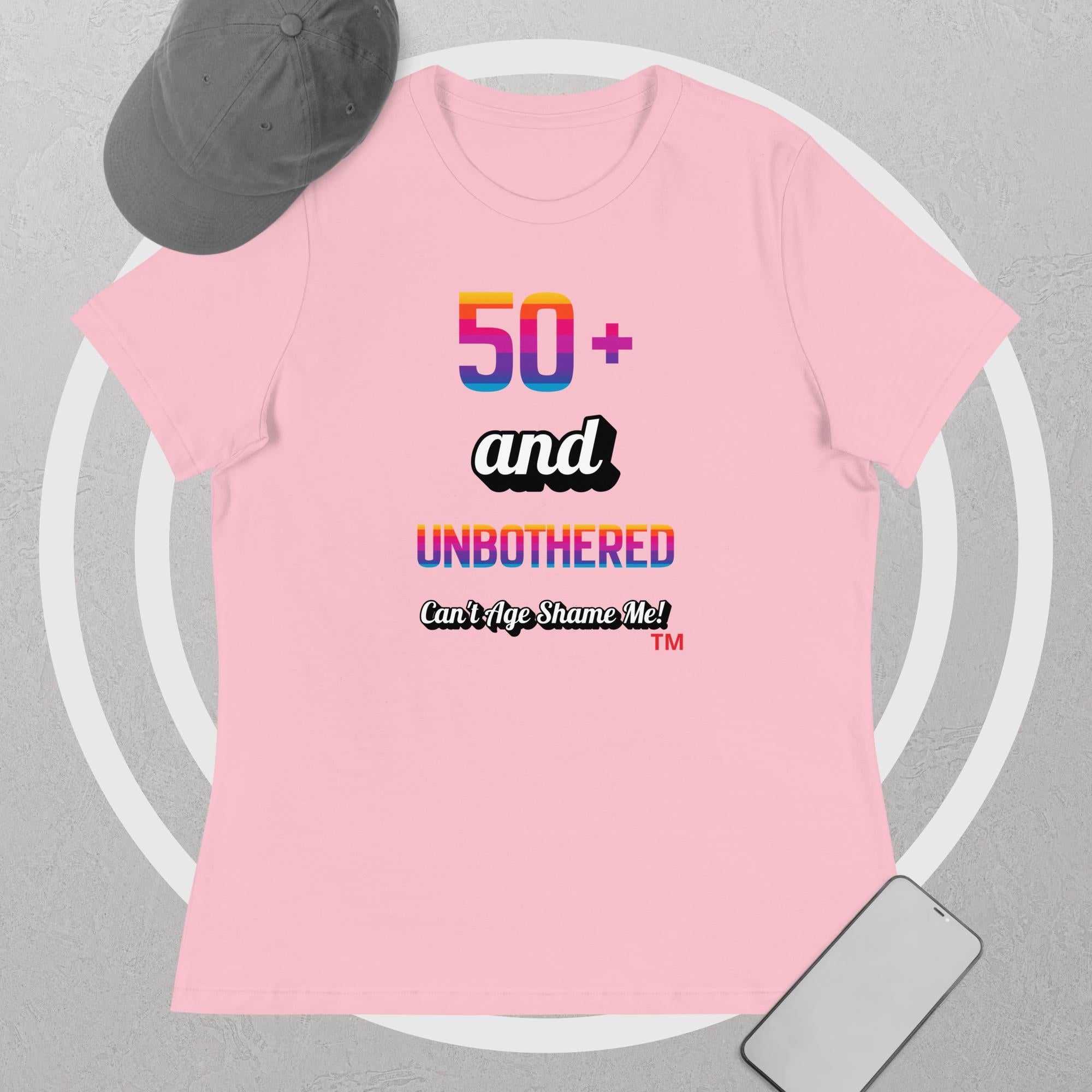 Pink t-shirt with colorful text design on a gray background