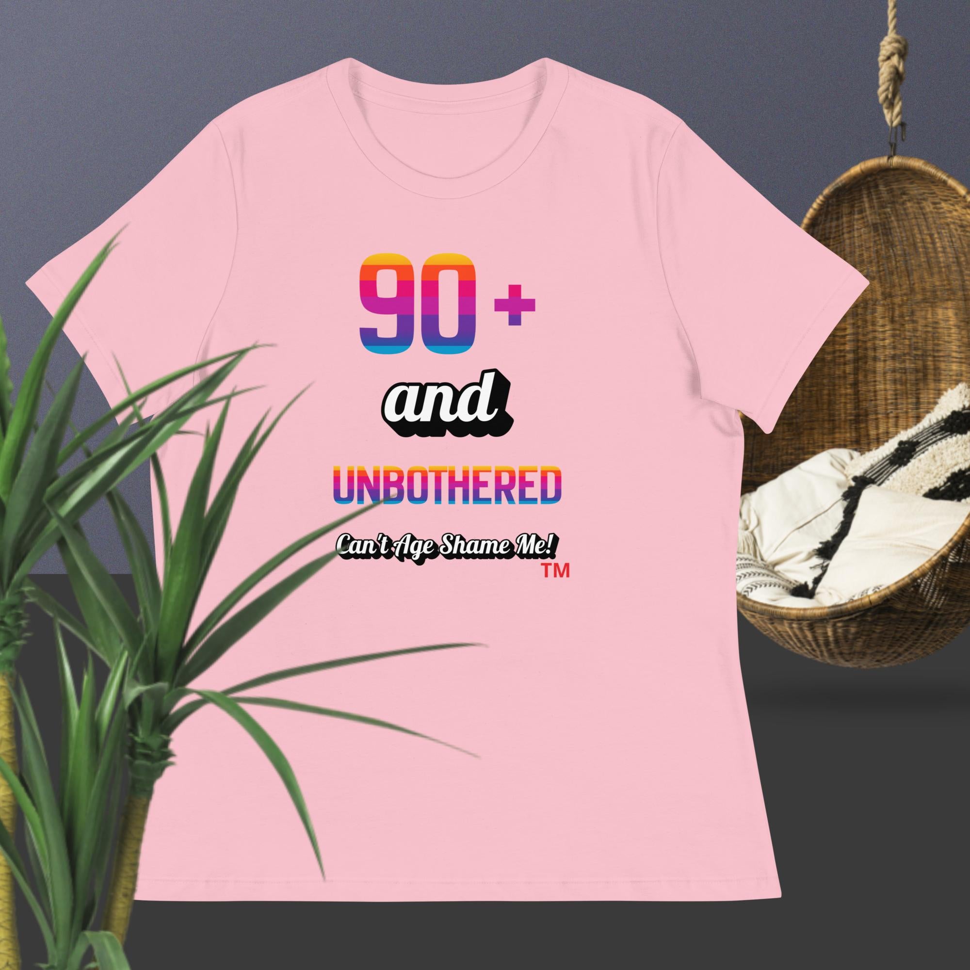 Pink t-shirt with colorful text design on a dark background