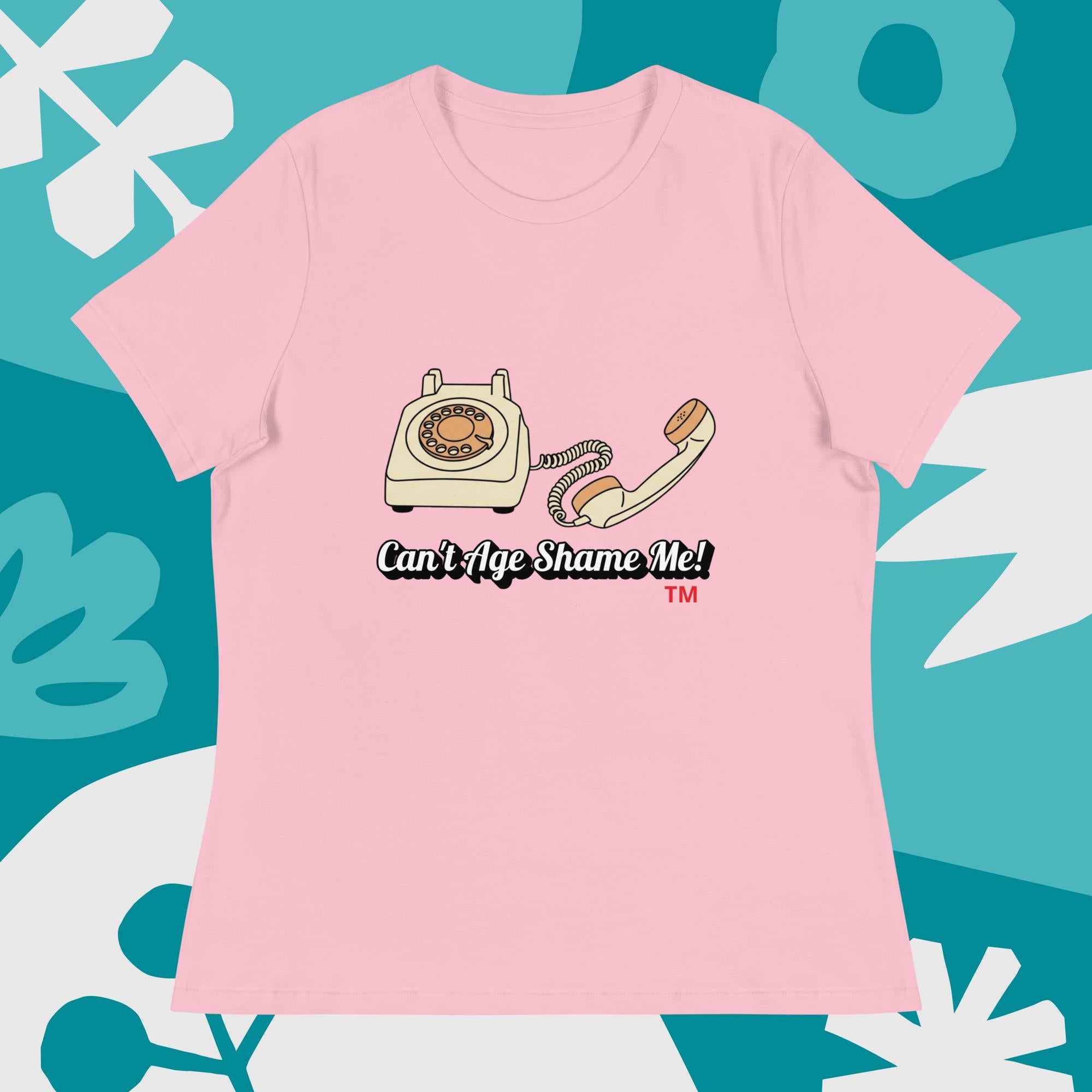 pink  t-shirt with a vintage telephone graphic and text  can't age shame me on a blue and white abstract background