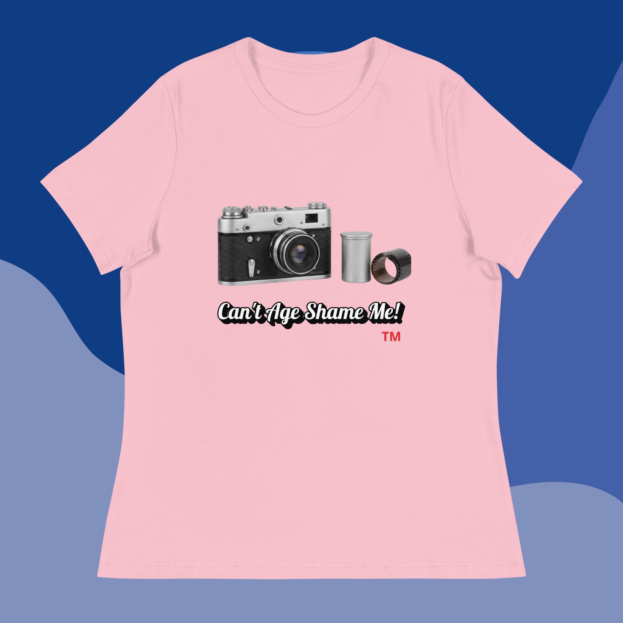 Pink t-shirt with camera graphic and text 'Can't Age Shame Me!' on a blue background