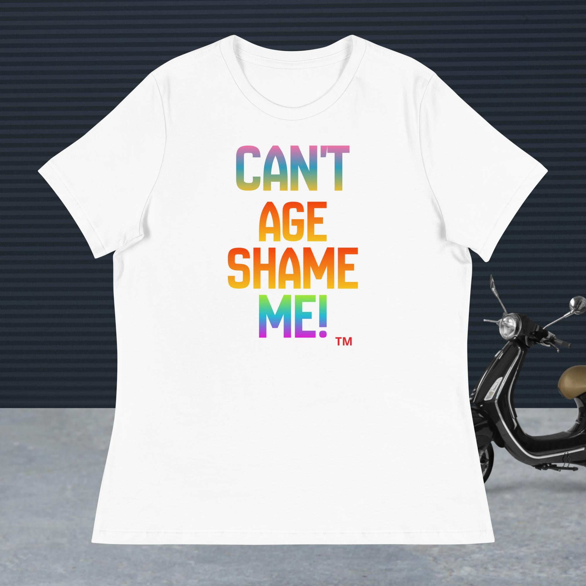 White t-shirt with colorful text 'CAN'T AGE SHAME ME!' on a dark background with a scooter.