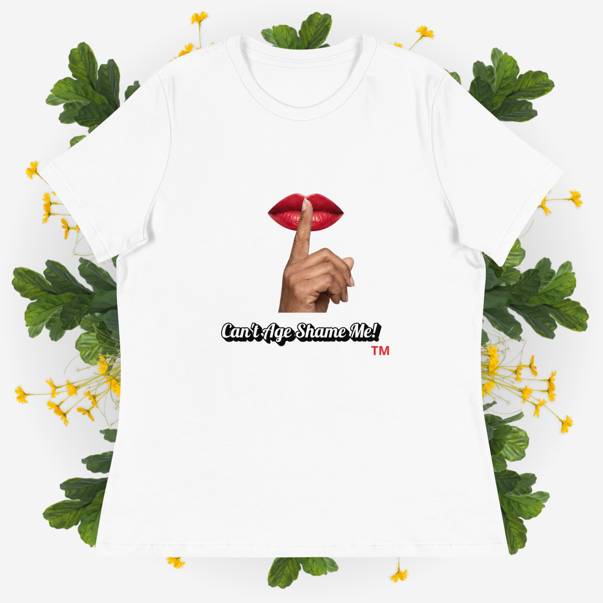 White  t-shirt with graphic design and text 'Can't Age Shame Me' on a decorative background with leaves and flowers.