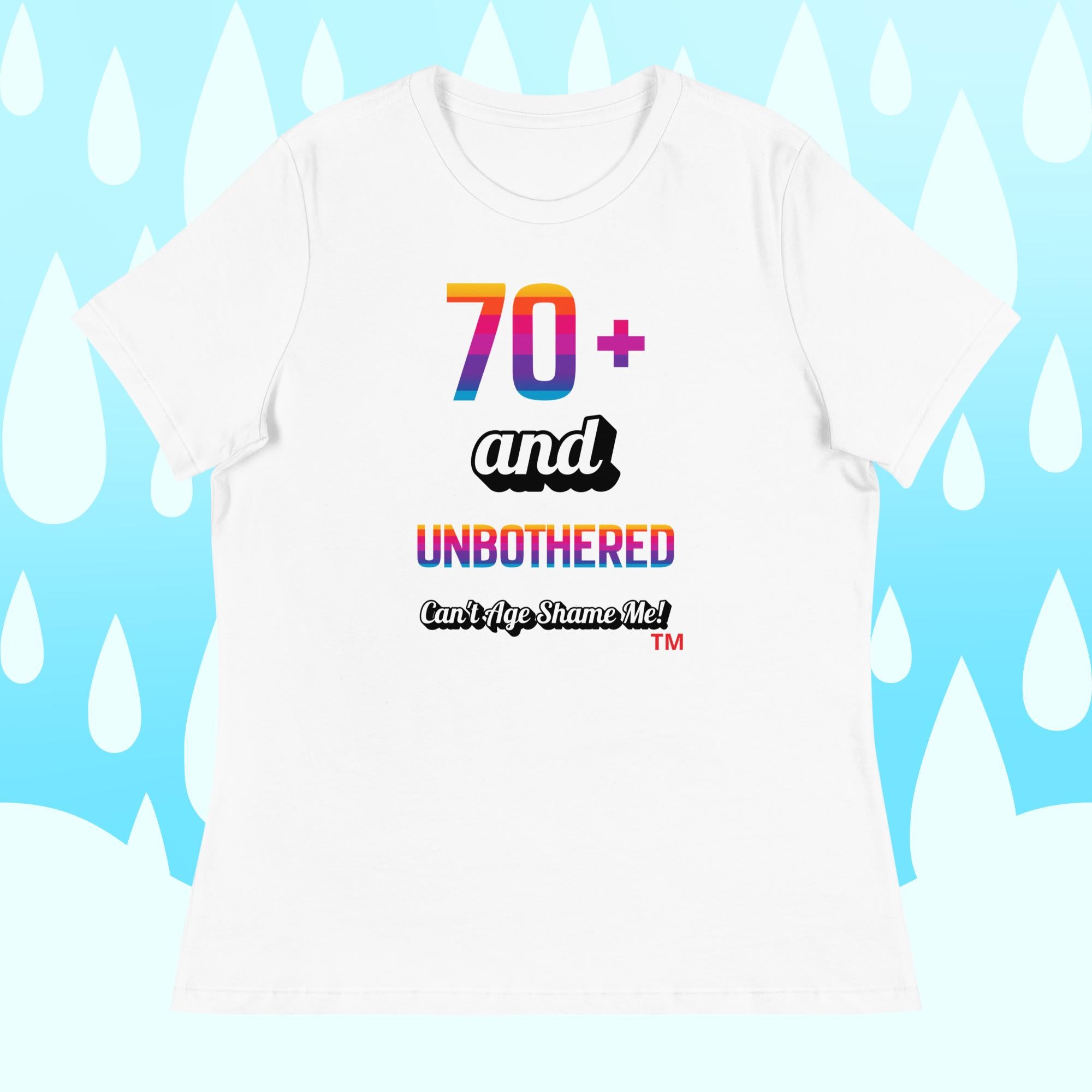 White t-shirt with colorful text design on a light blue background with white shapes.